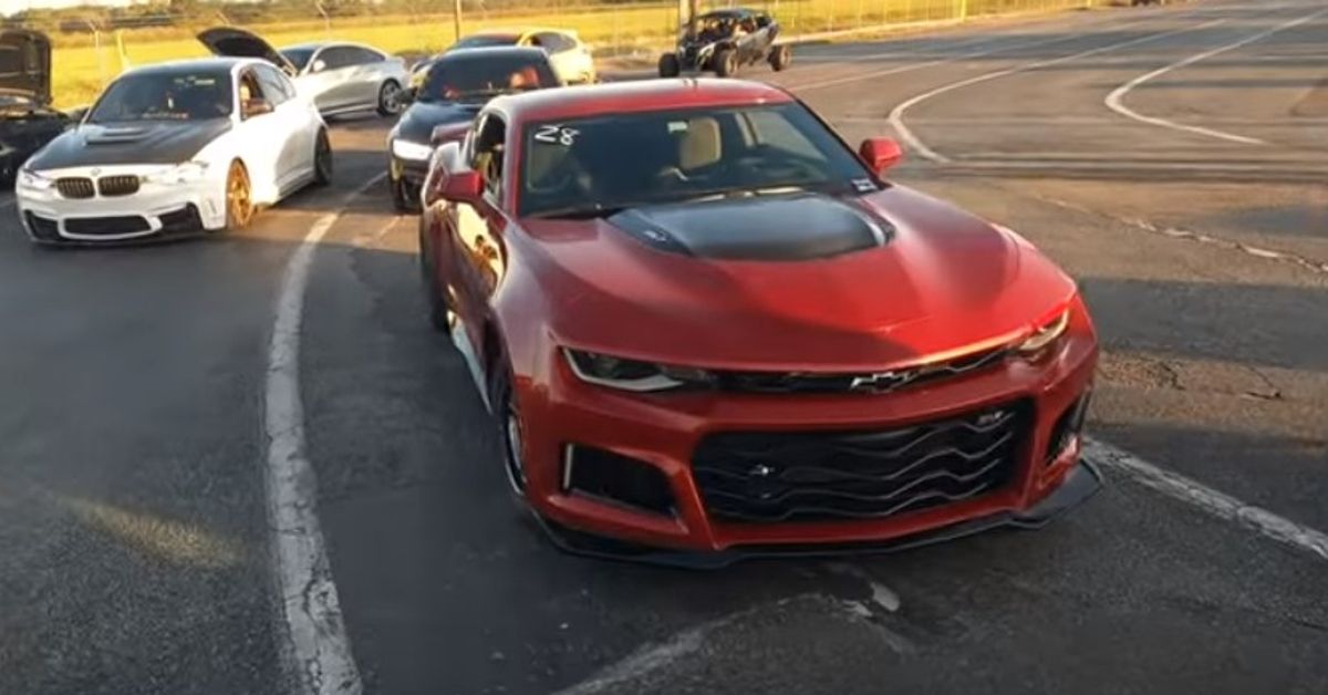 Tesla Plaid Channel YouTube Red Chevy Camaro ZL1 front view at the drag