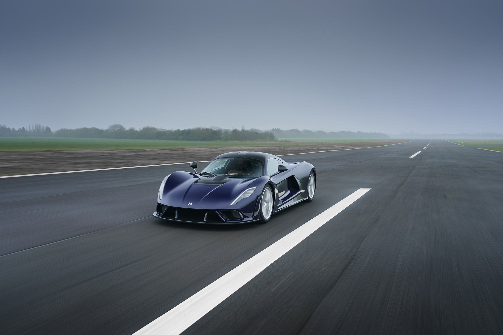 The Hennessey Venom F5 speeds up on the road. 
