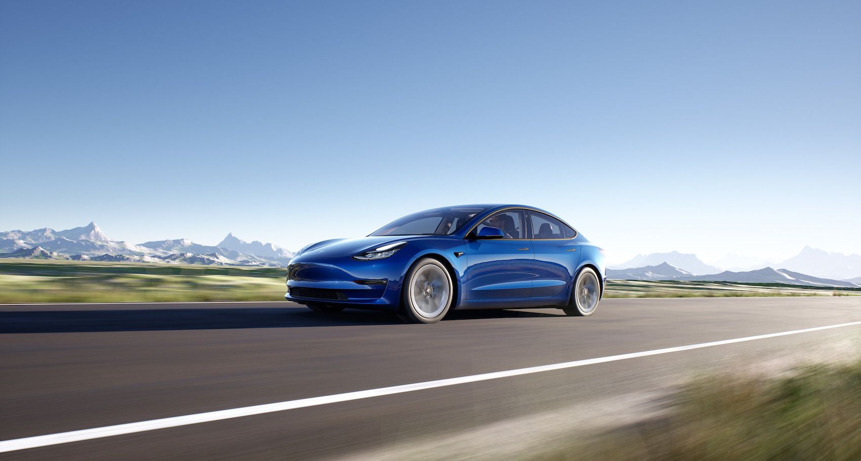 Blue 2023 Tesla Model 3 on the road