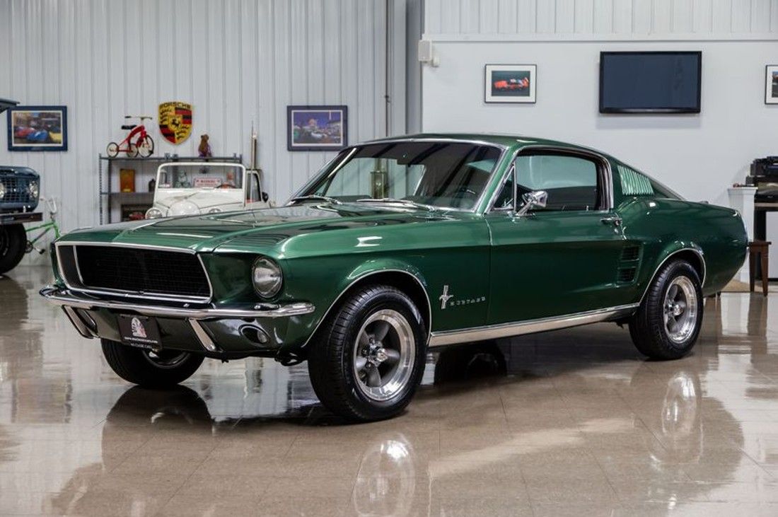 Green 1967 Ford Mustang Fastback inside a garage