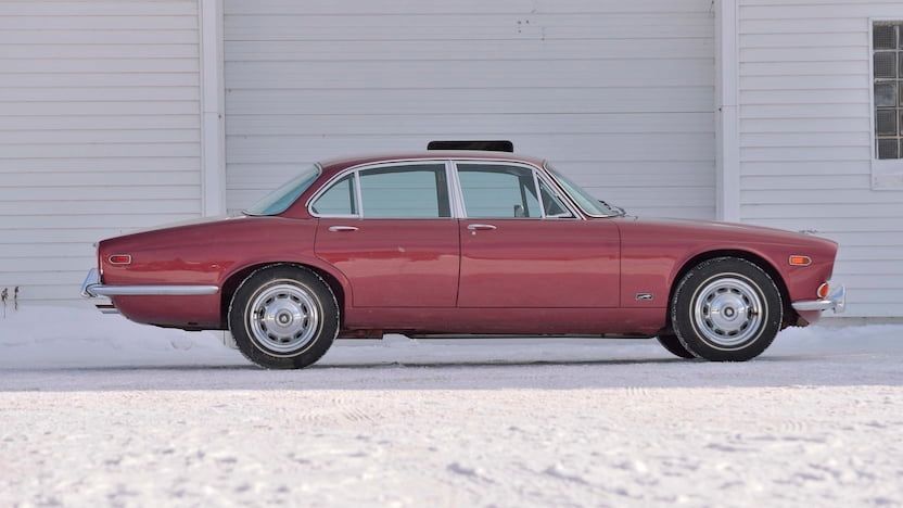Red 1972 Jaguar XJ6 on the road