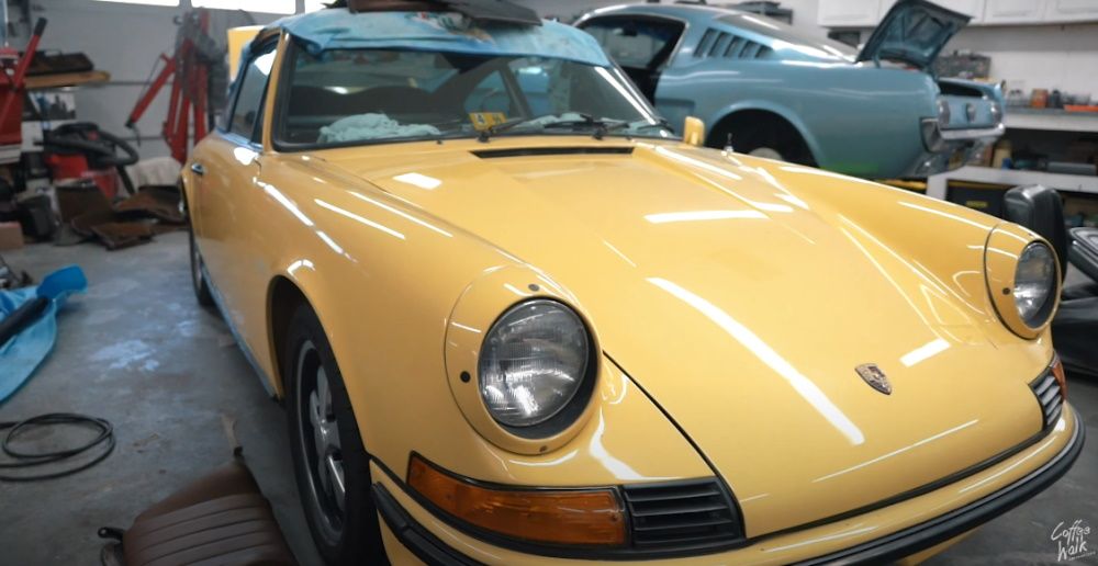 A yellow restored Porsche 911 at Dennis Collins' garage, front