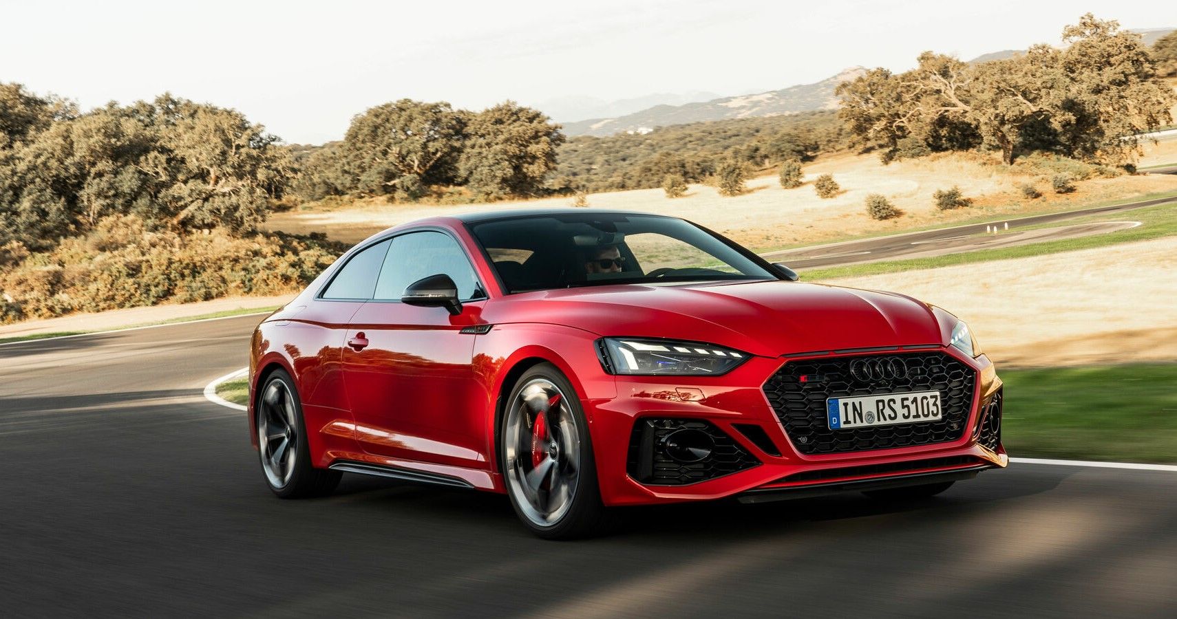 2023 Audi RS 5 coupe with the Competition Package accelerating on racetrack