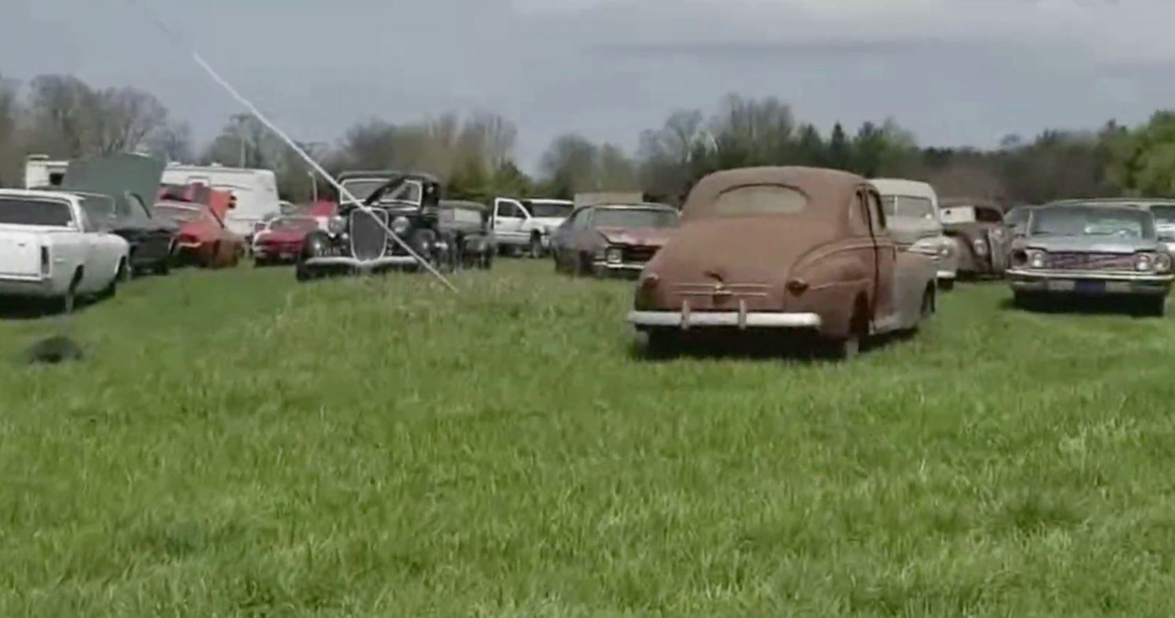 Field of Cars and barn finds, view of collection from distance