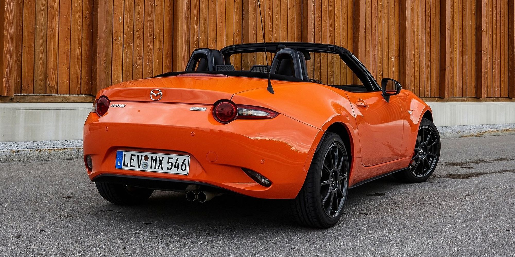 Orange Mazda MX-5 in the driveway