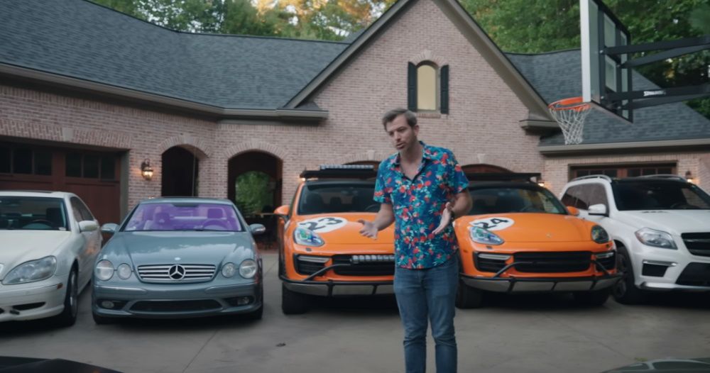 Ed Bolian in front of his Mercedes-Benz and Porsche models