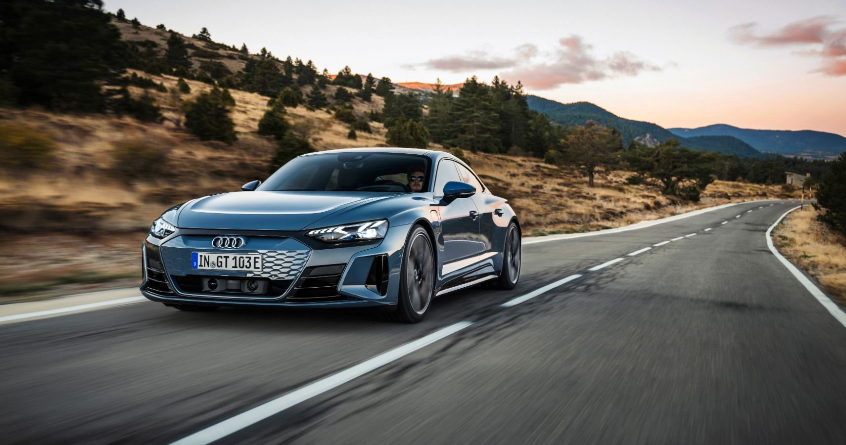 The Audi e-tron GT speeds up on the road. 