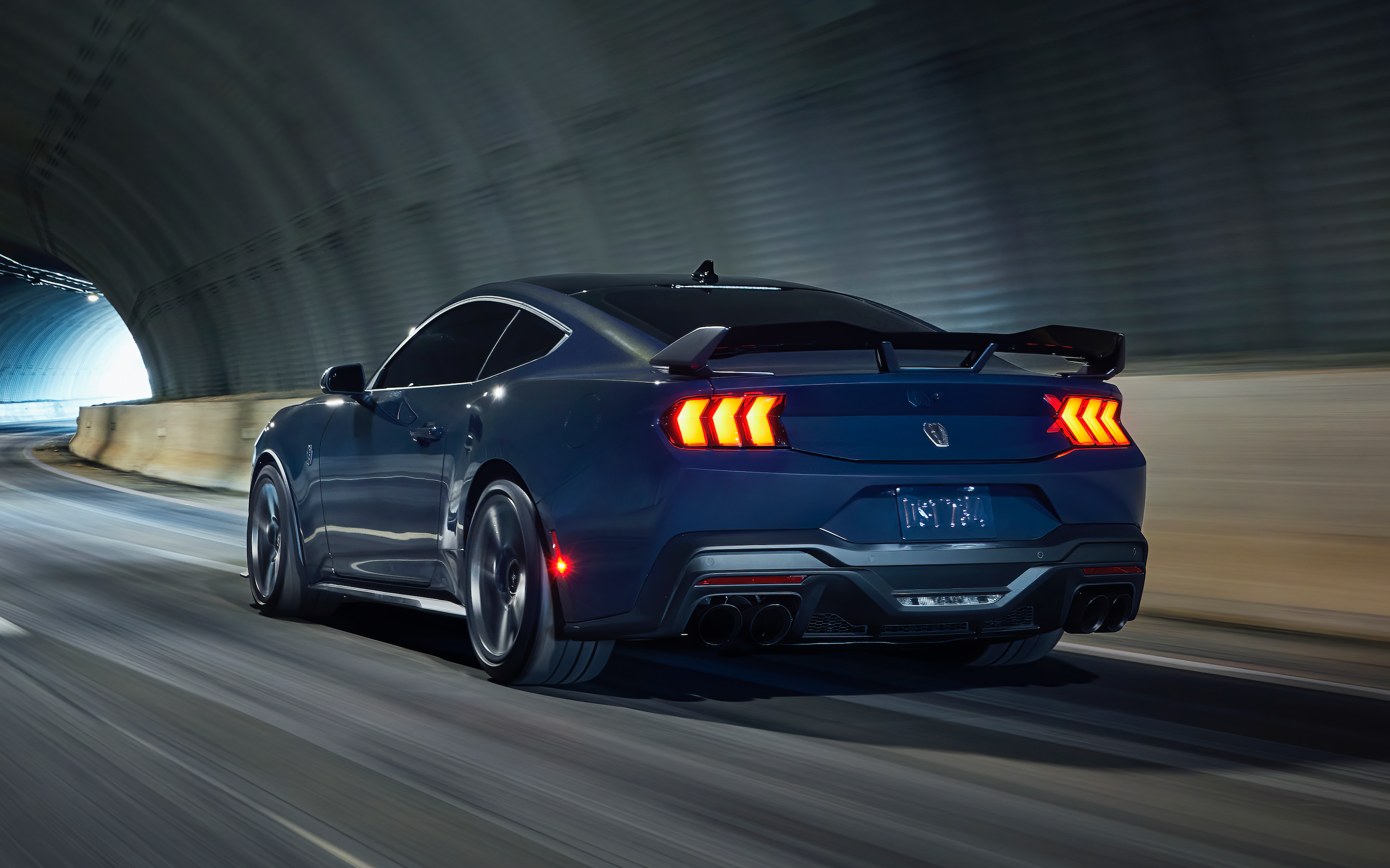 2024 The dark horse of the blue Ford Mustang coming out of the tunnel