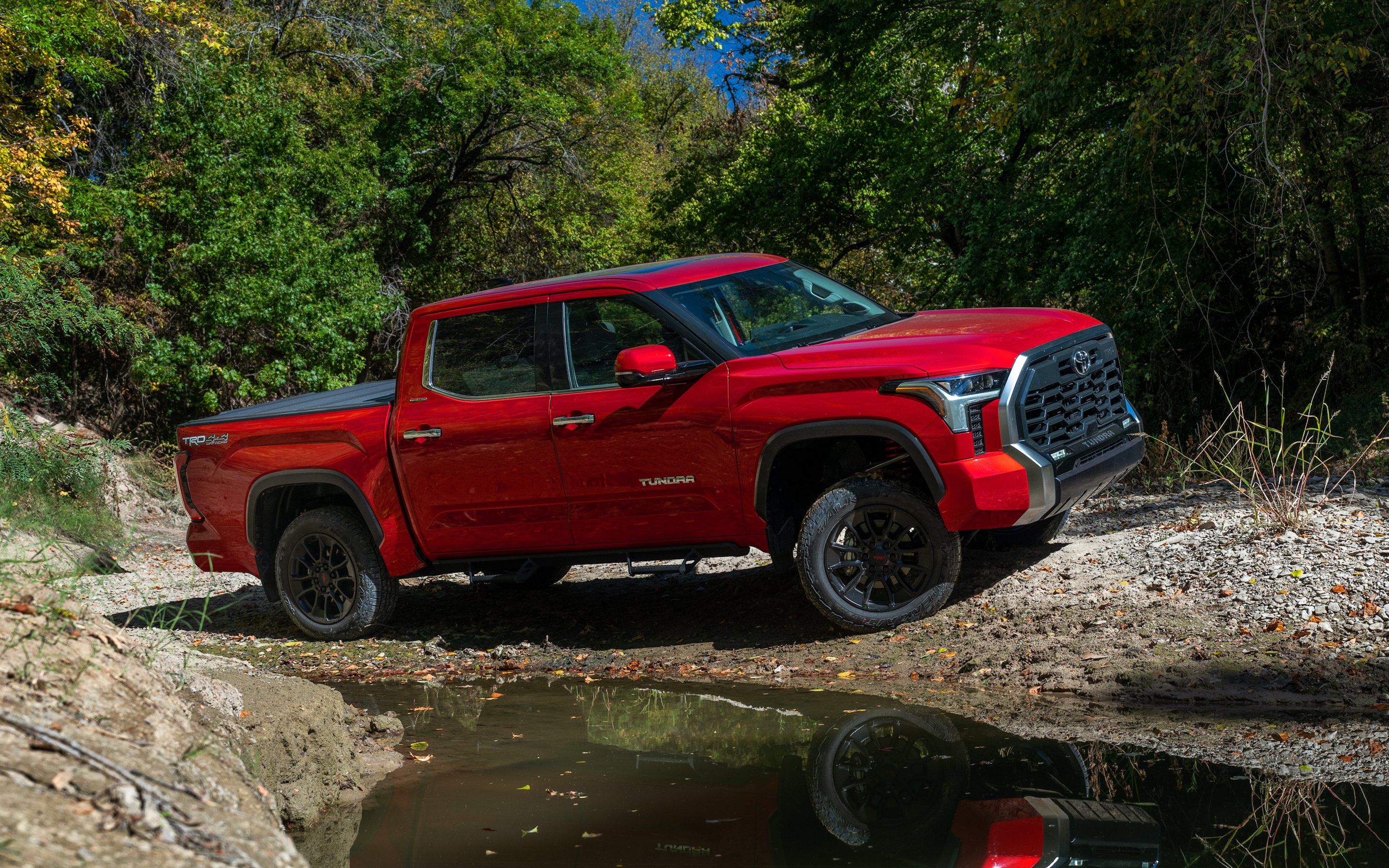 Red Toyota Tundra Tackling Terrain