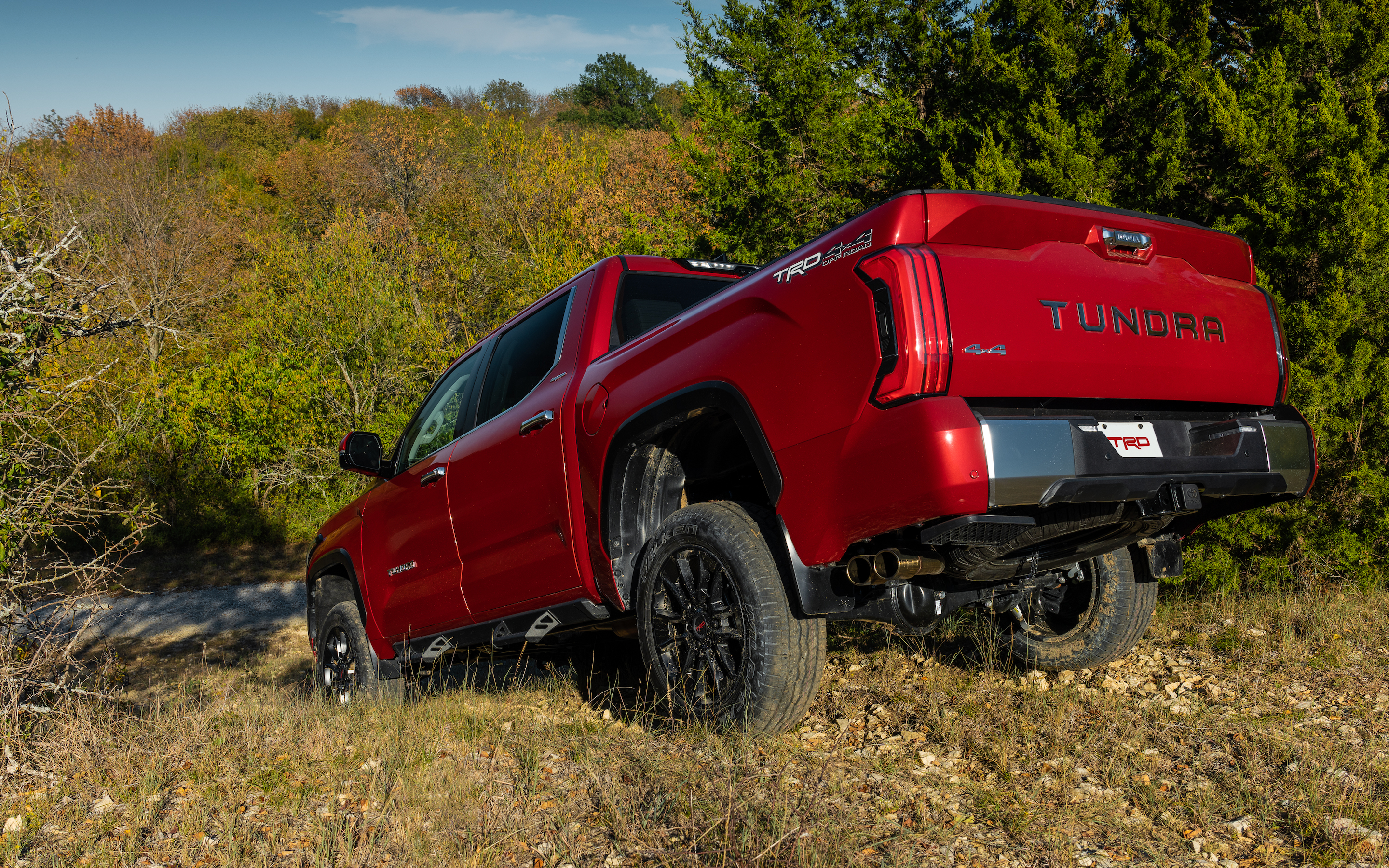Red Toyota Tundra Driving Down An Incline
