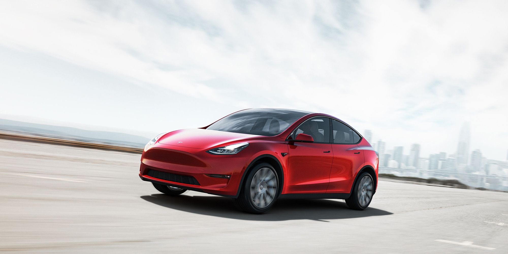Tesla Model Y Front Quarter Red Driving