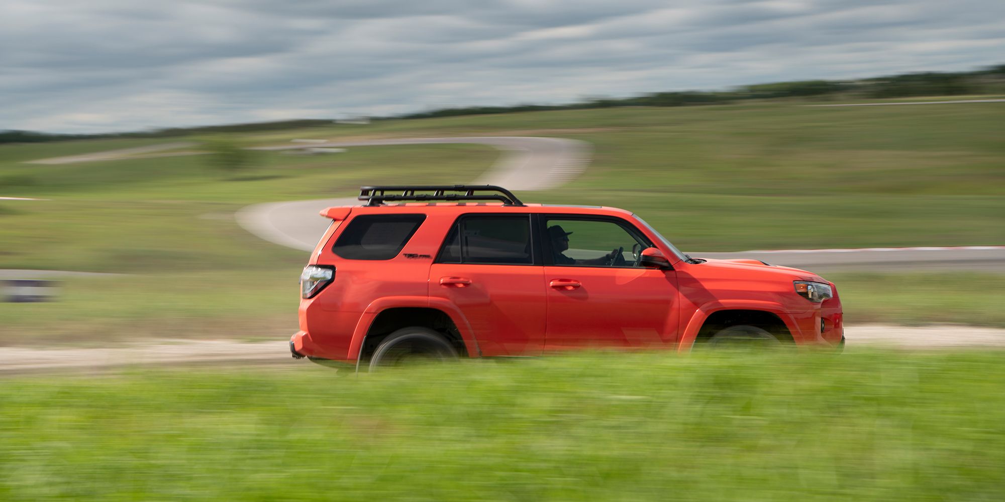 Red Toyota 4Runner Side Profile Driving