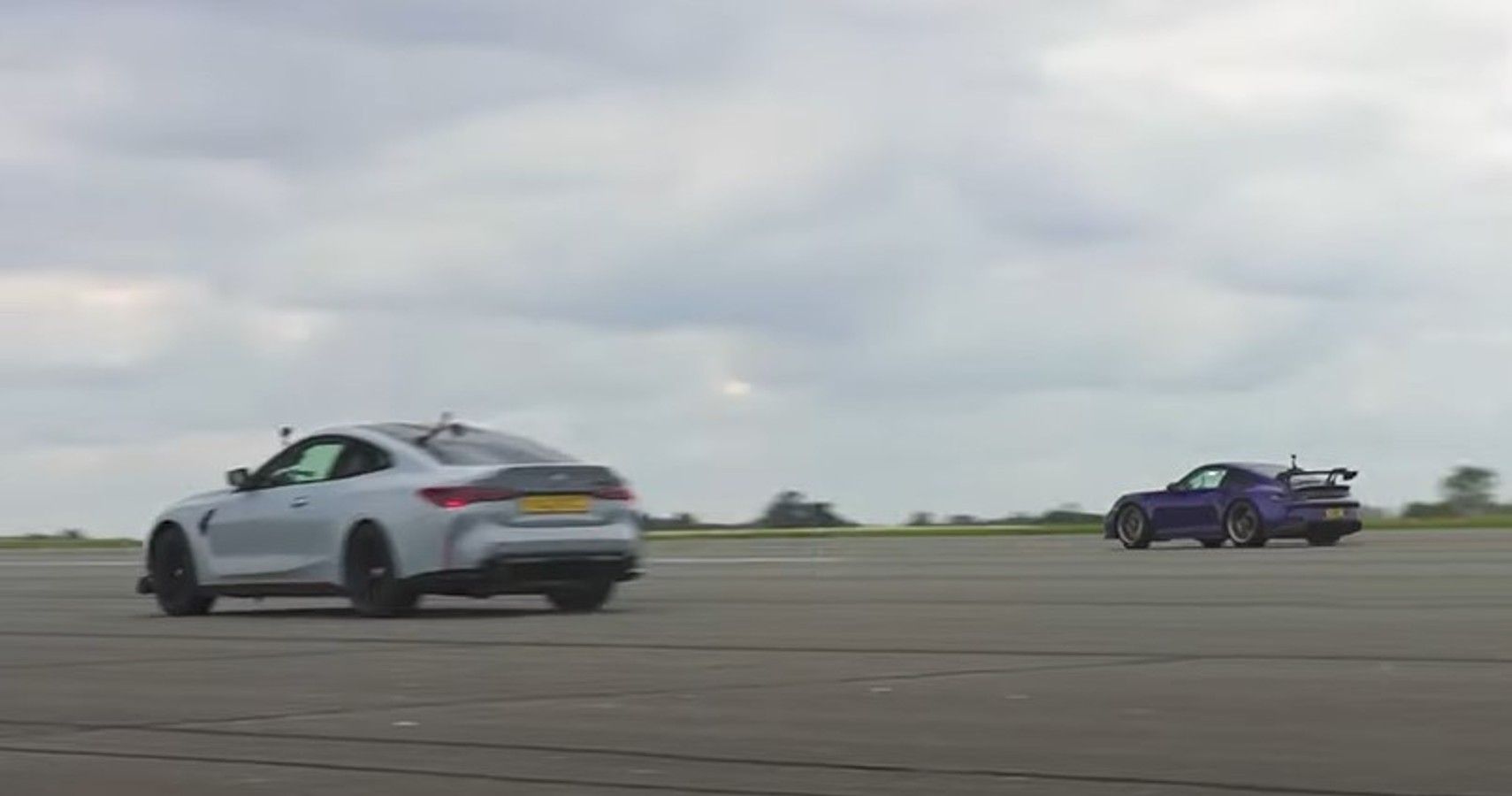 911 versus M4, rear quarter view racing on track