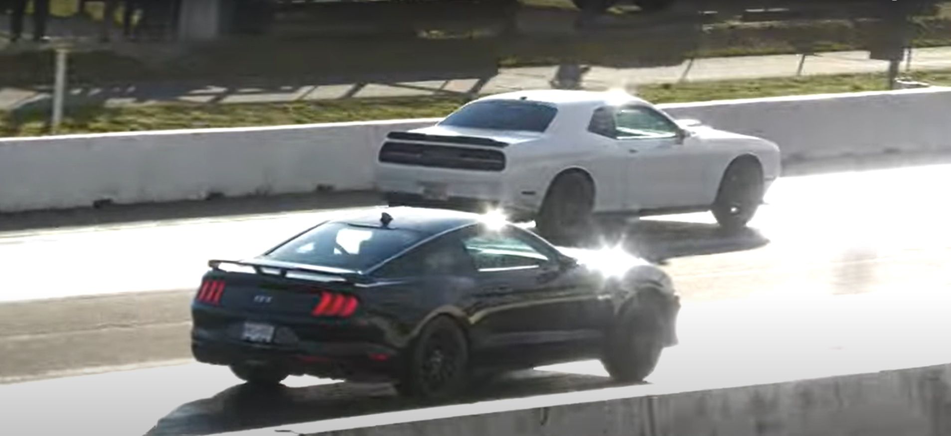 White Dodge Challenger Scat Pack Beating A Black Ford Mustang GT At the Drag Strip