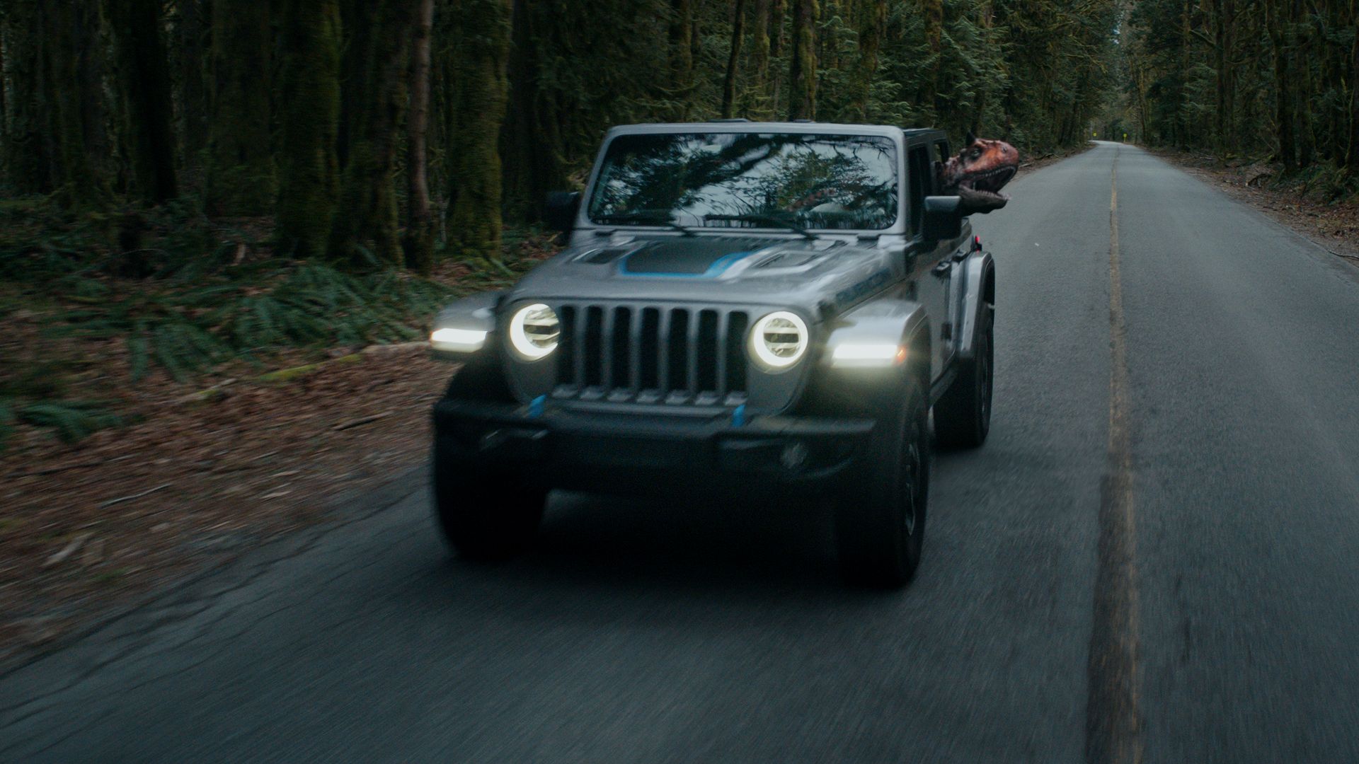 Jeep Wrangler 4xe speeds up the road. 