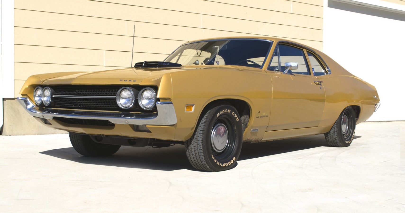  1970 Ford Falcon 429 Cobra Jet in gold front third quarter view