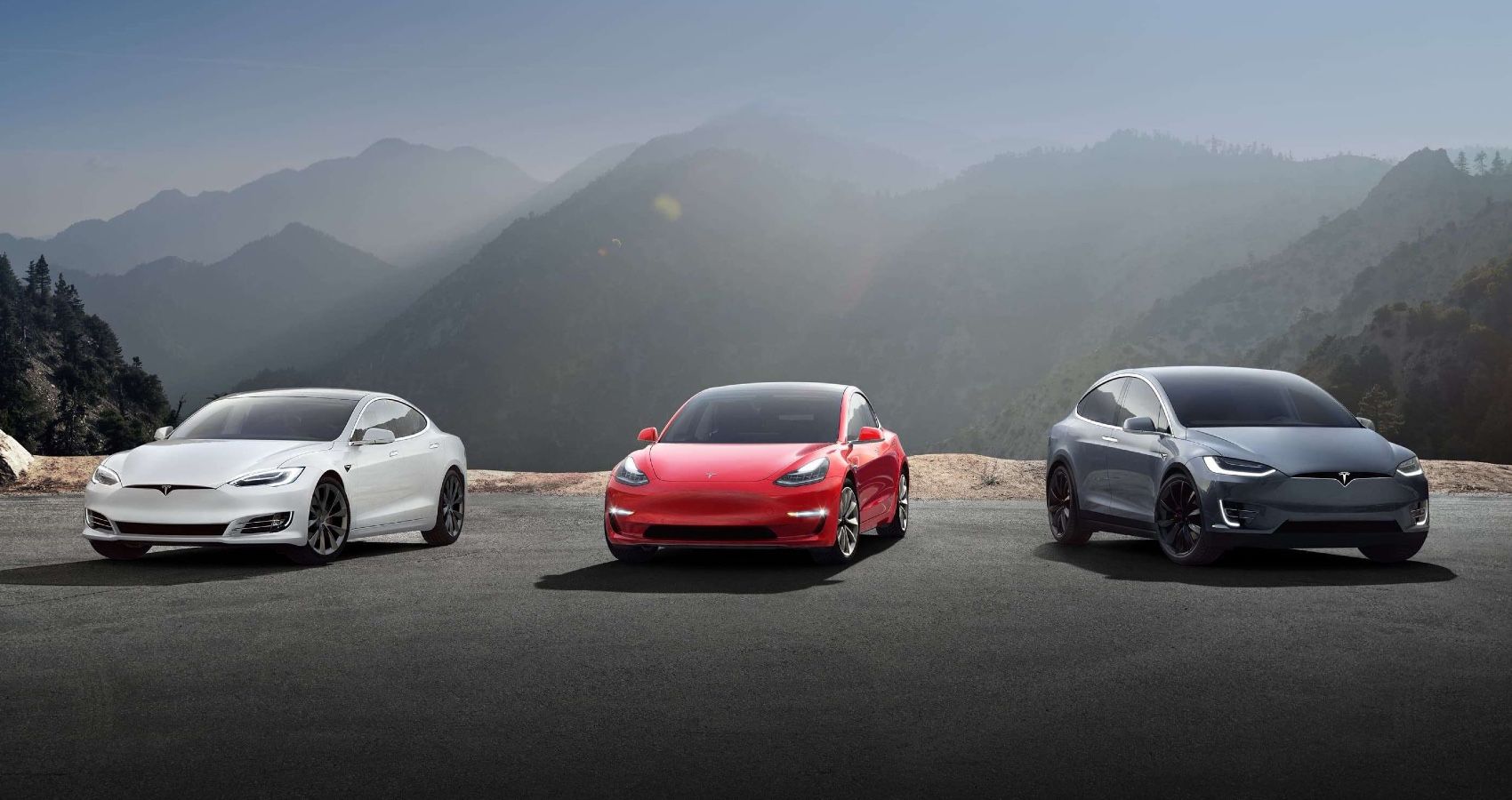 Three Tesla cars in the mountains