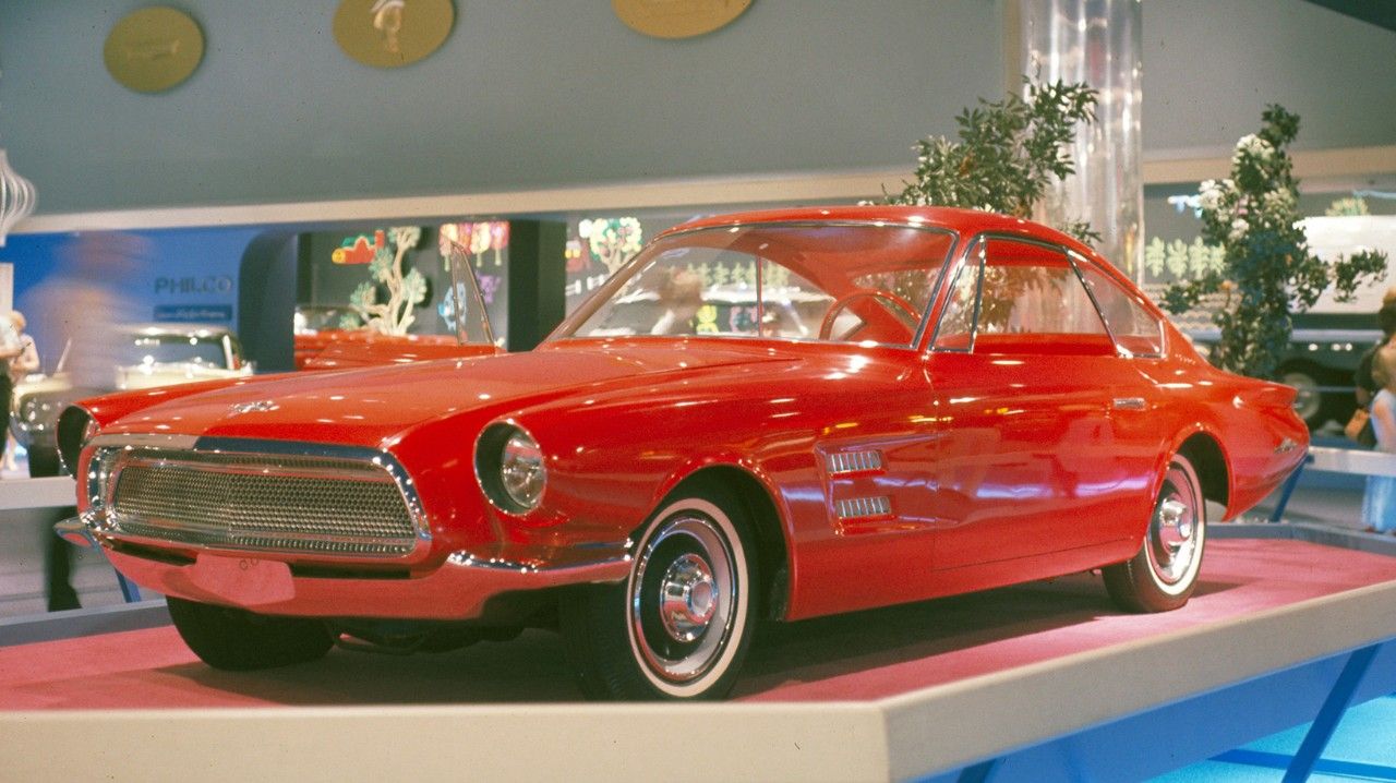 A red 1964 Ford Allegro concept on display at the auto show