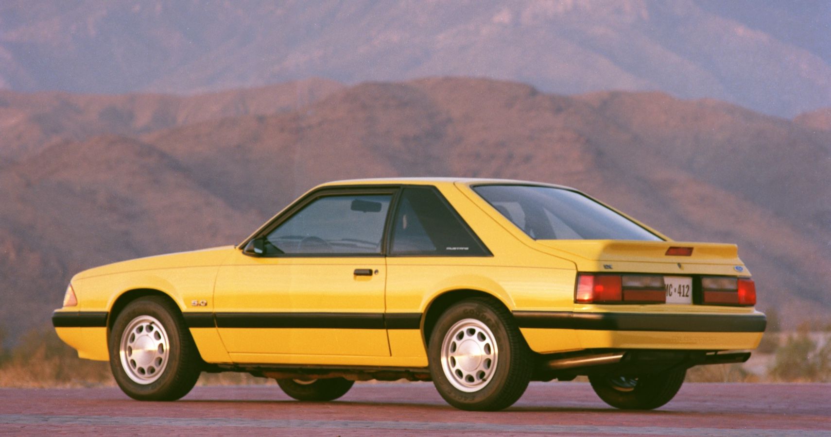 1990 Ford Mustang LX Hatchback Yellow in Desert Mountains