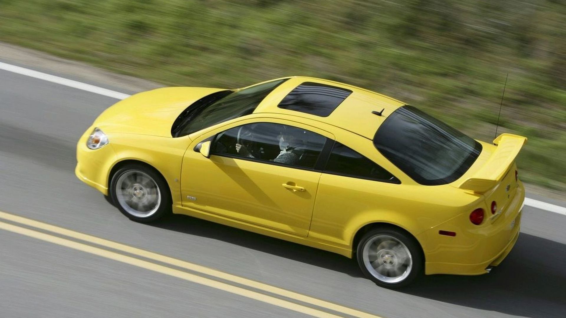 A yellow 2008 Chevrolet Cobalt SS driving