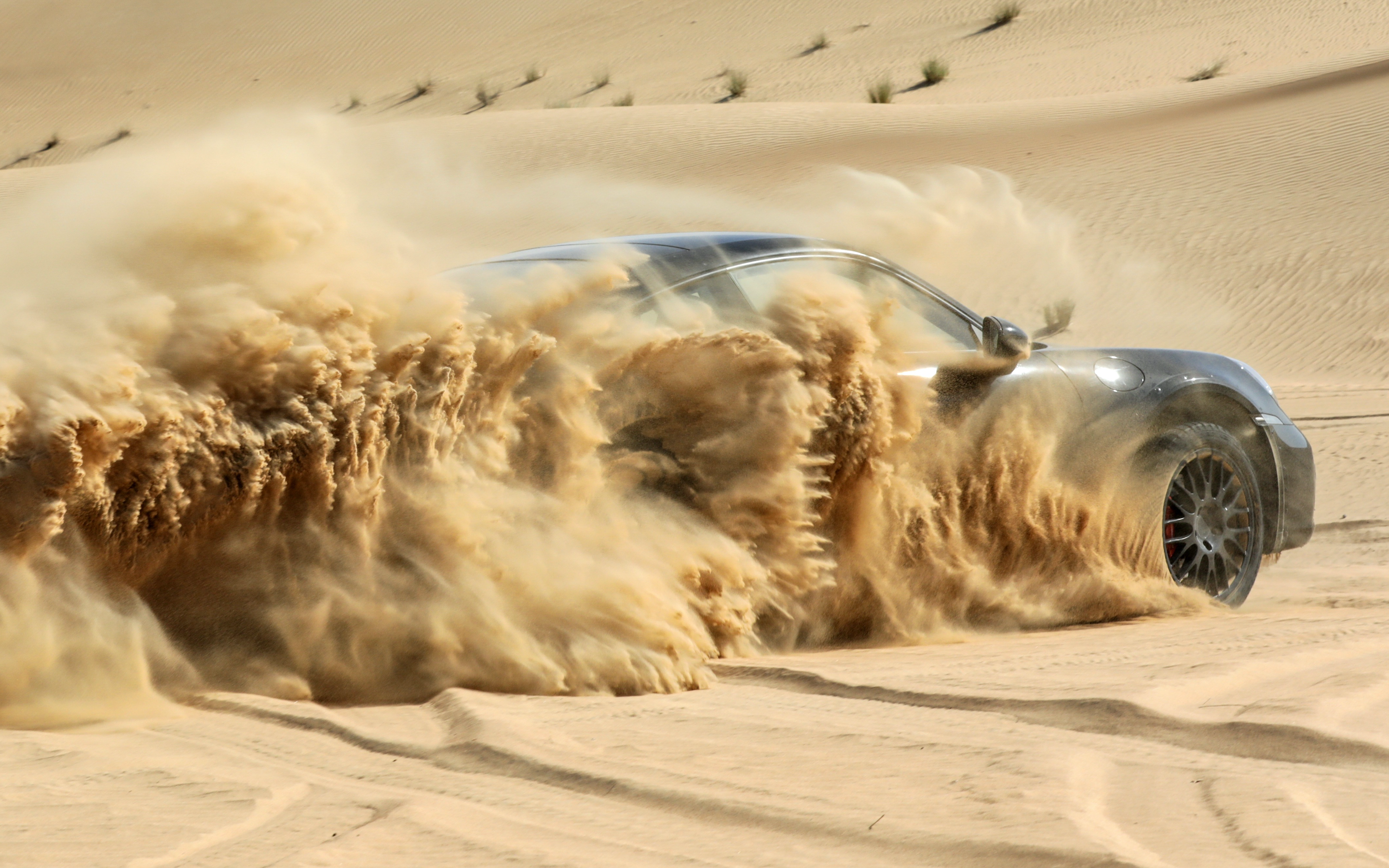 Black 2023 Porsche 911 Dakar Kicking Up Desert Sand
