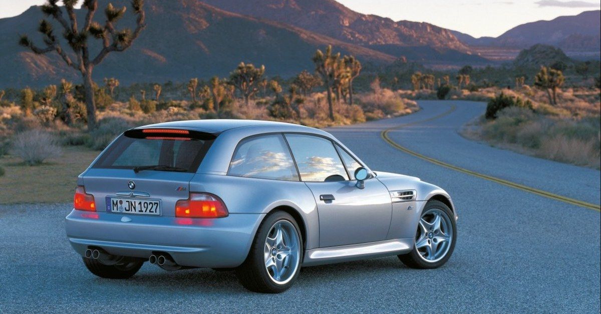 A silver BMW Z3 M Coupe parked on the side of the road
