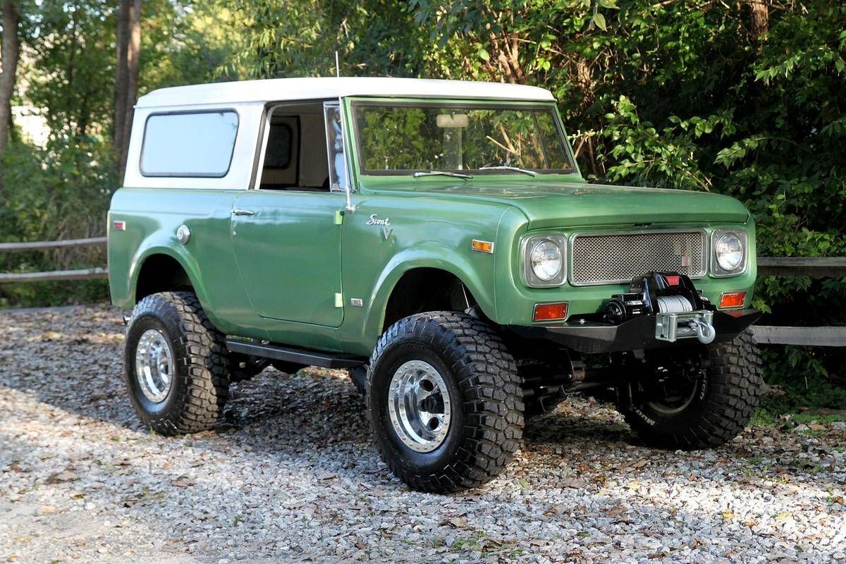 International Harvester Scout 800B front right, green and parked in gravel