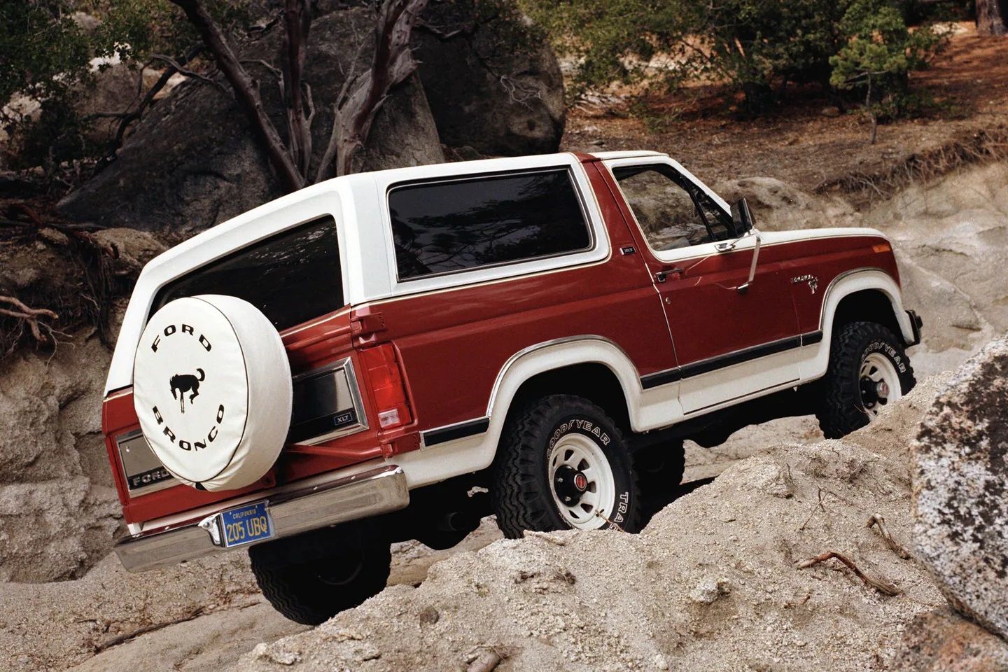 The 1981 Ford Bronco goes over a challenging terrain. 