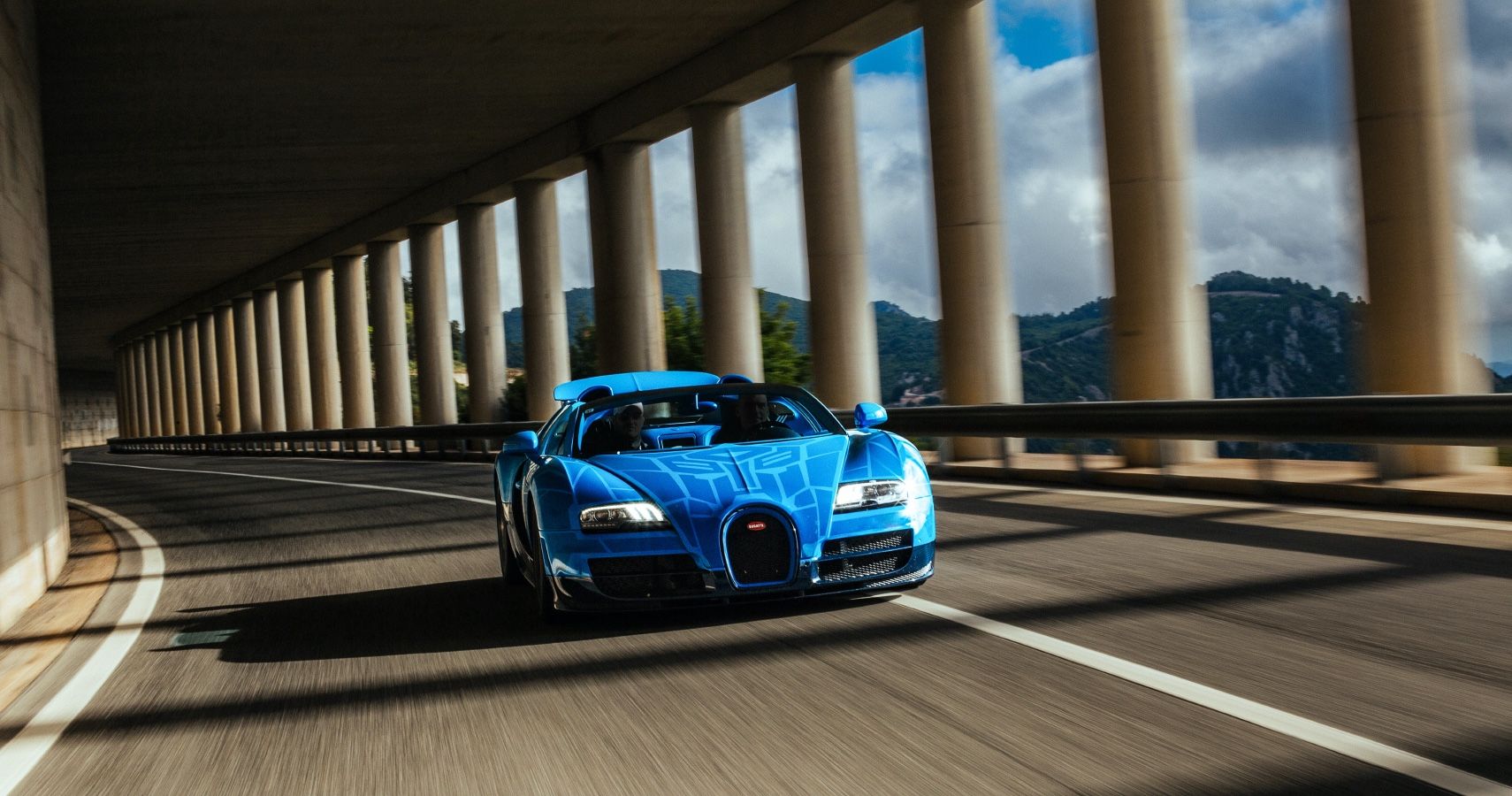 Blue Bugatti Chiron Super Sport Driving on Covered Highway