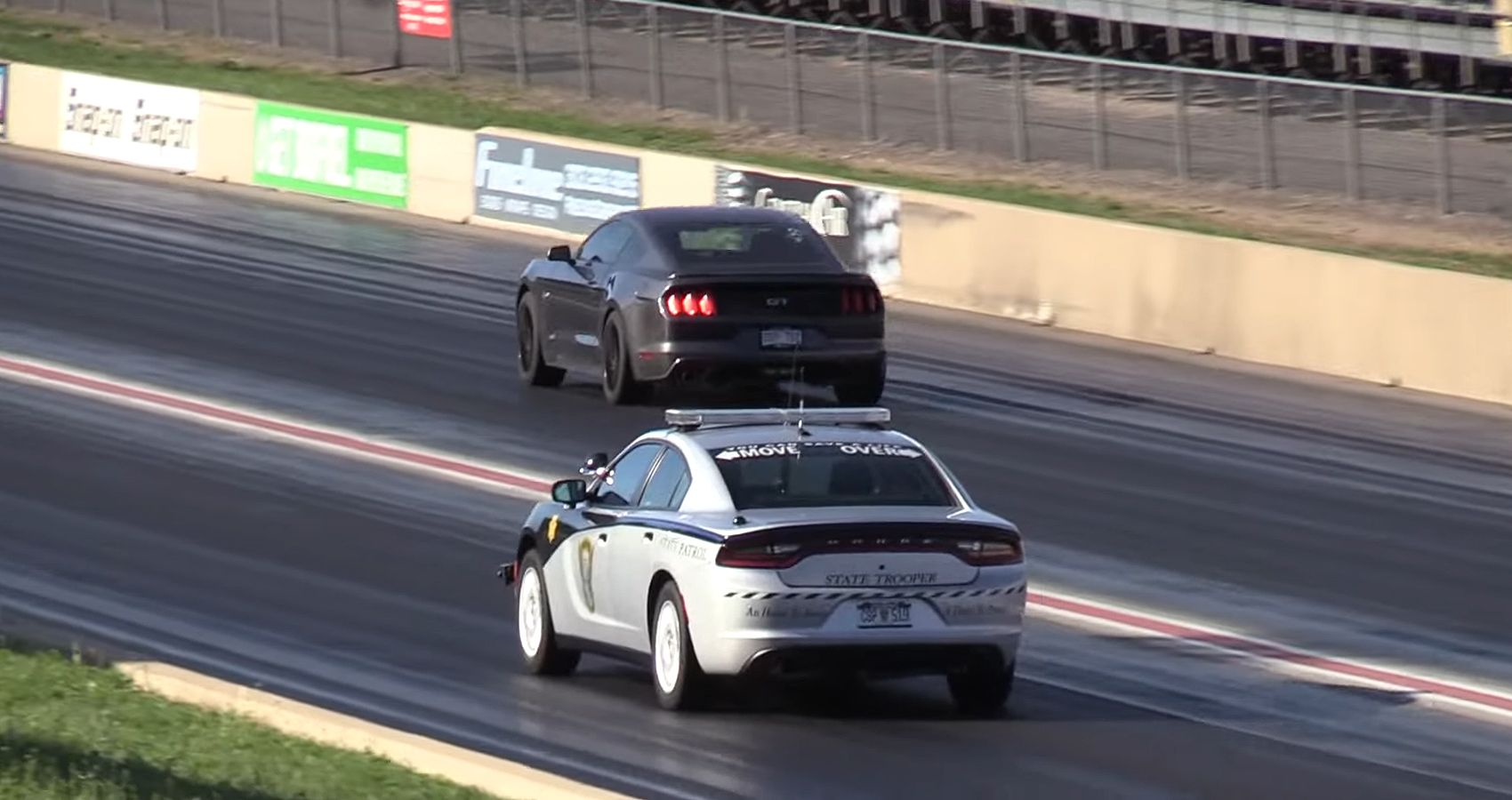 Dodge Charger Police Car and Ford Mustang GT Battle It Out In A Drag Race