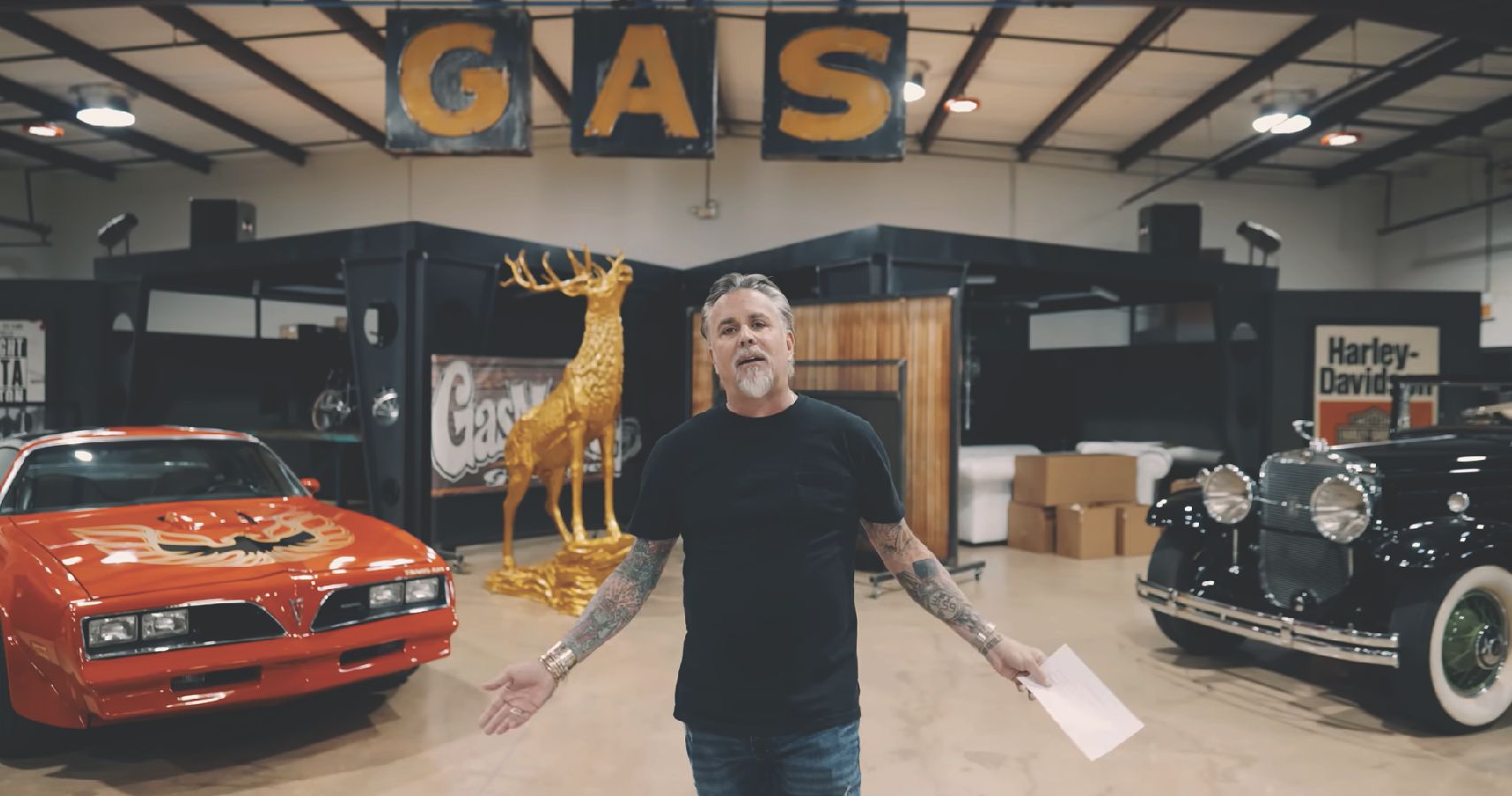 Gas Monkey Garage Richard Rawlings in front of cars, Rawlings in center at front