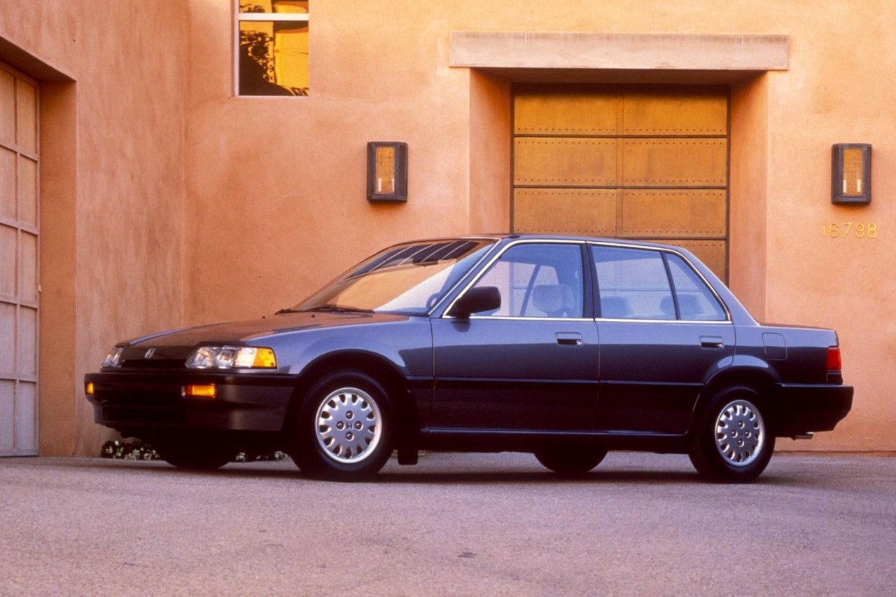 The 1988 Honda Civic Sedan parked in front of a private house. 