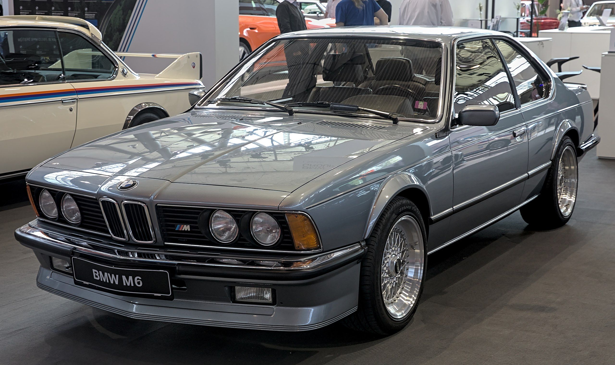 Blue BMW 635CSi E24 parked in showroom