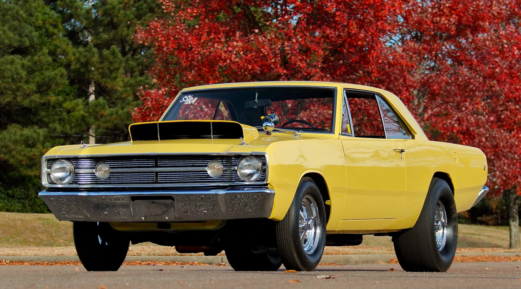 Yellow 1968 Dodge Dart LO23 parked outdoor