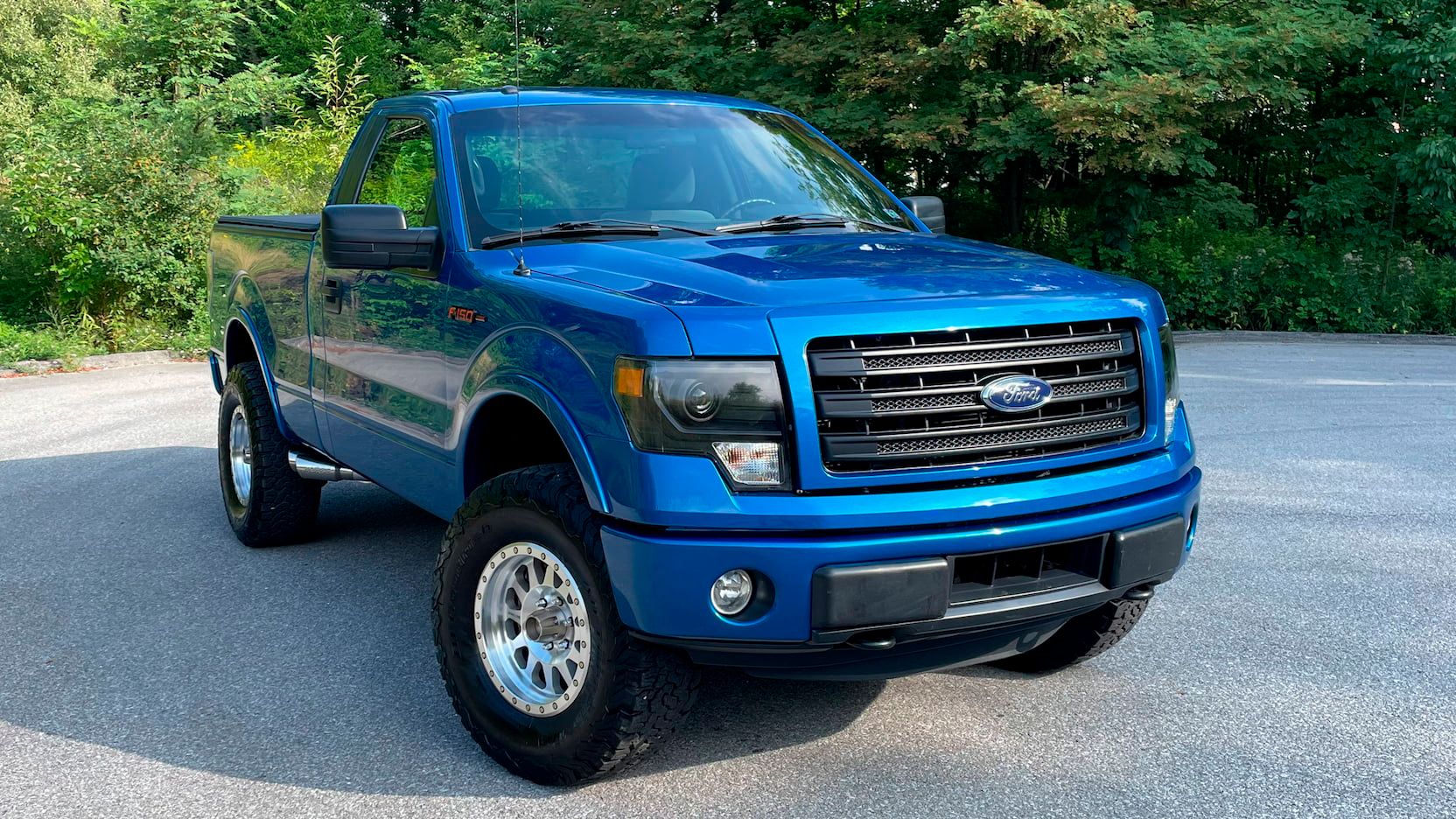 Blue 2011 Ford F-150 on the driveway
