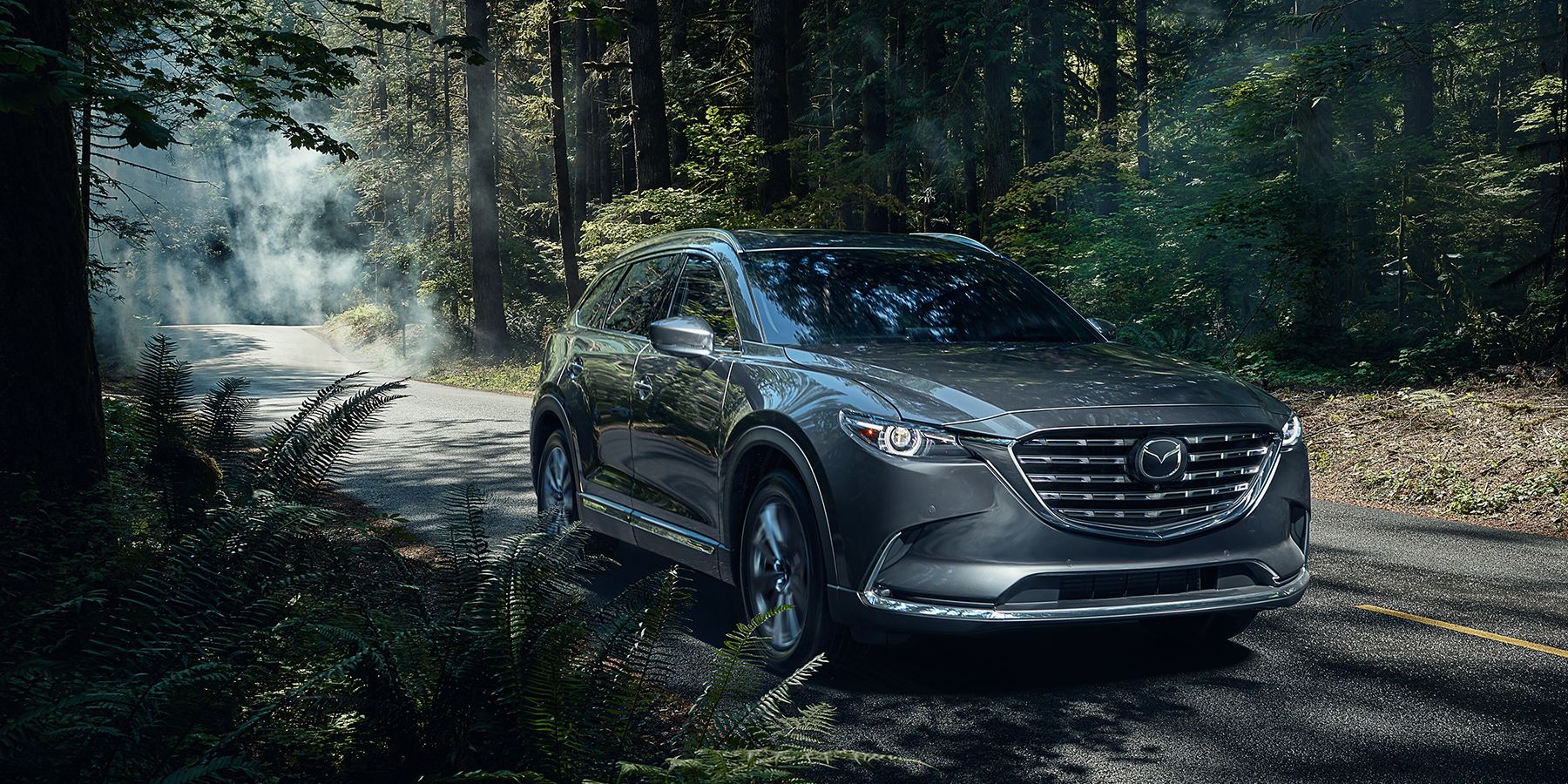 Mazda CX-9 gray 2023 driving through the woods