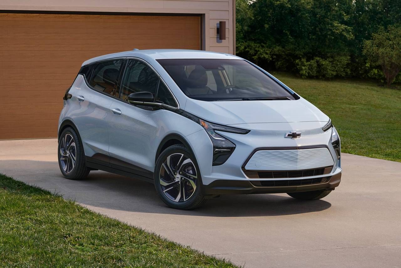 Pale blue 2023 Chevrolet Bolt EV 4 door hatchback parked in a driveway