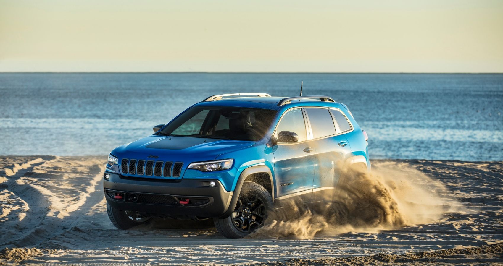 Off-roading in the 2023 Jeep Cherokee on a beach shore