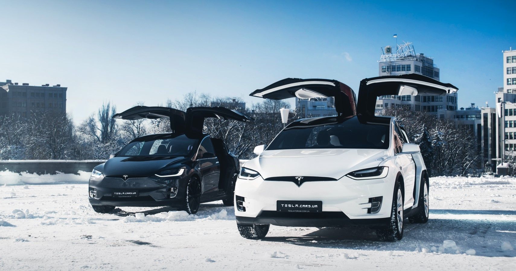 Two Tesla Model Xs in snow hd electric car wallpaper