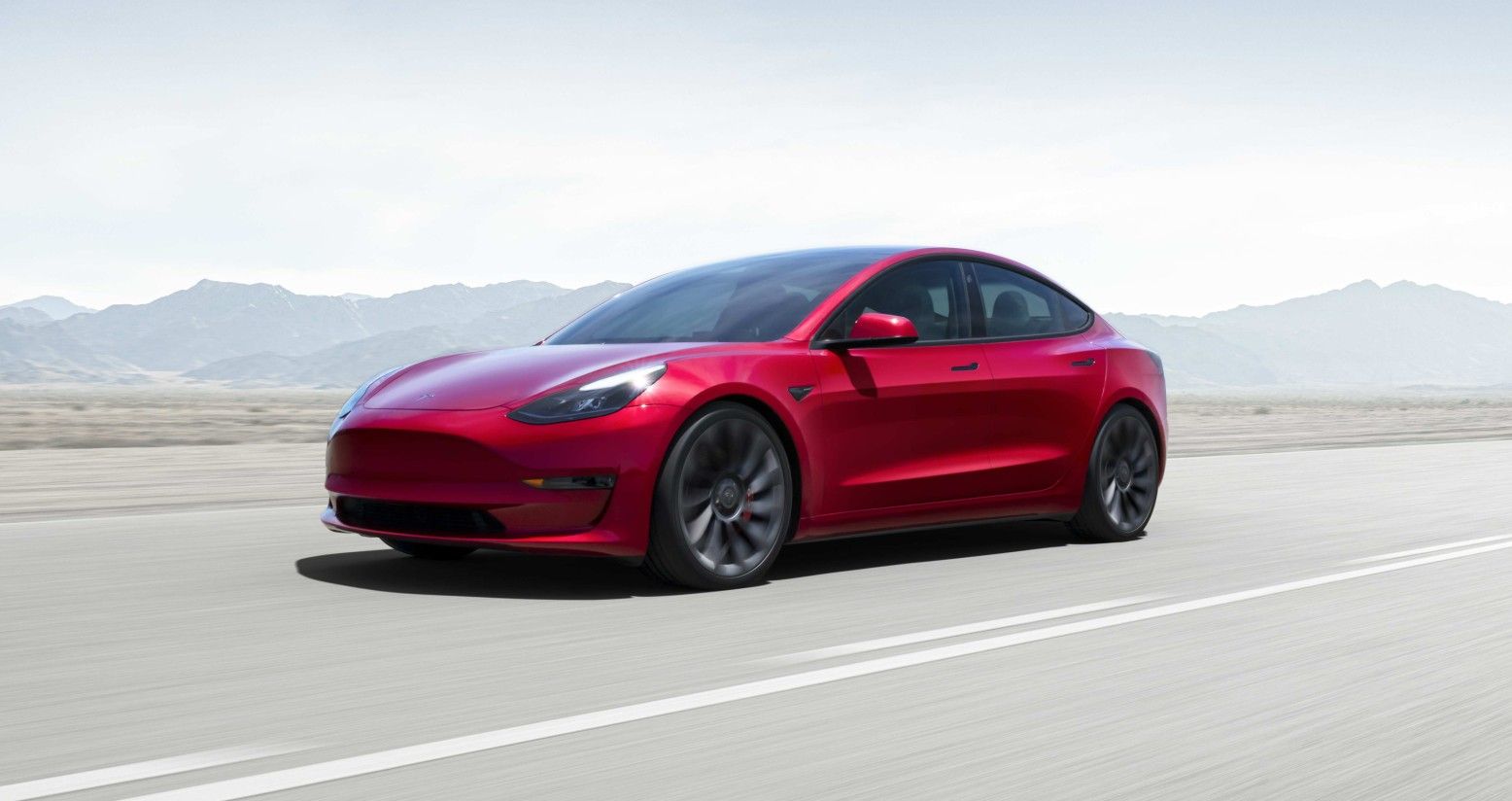 Tesla Model 3 three-quarter view on an open road