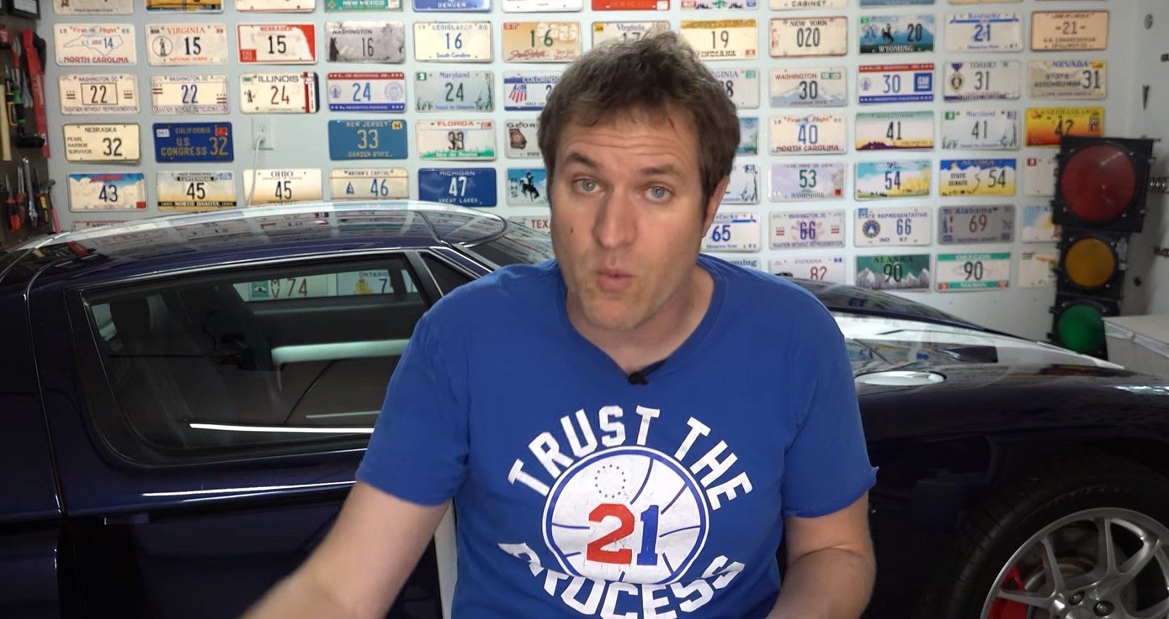 Doug DeMuro YouTube video in garage, front profile view of man talking