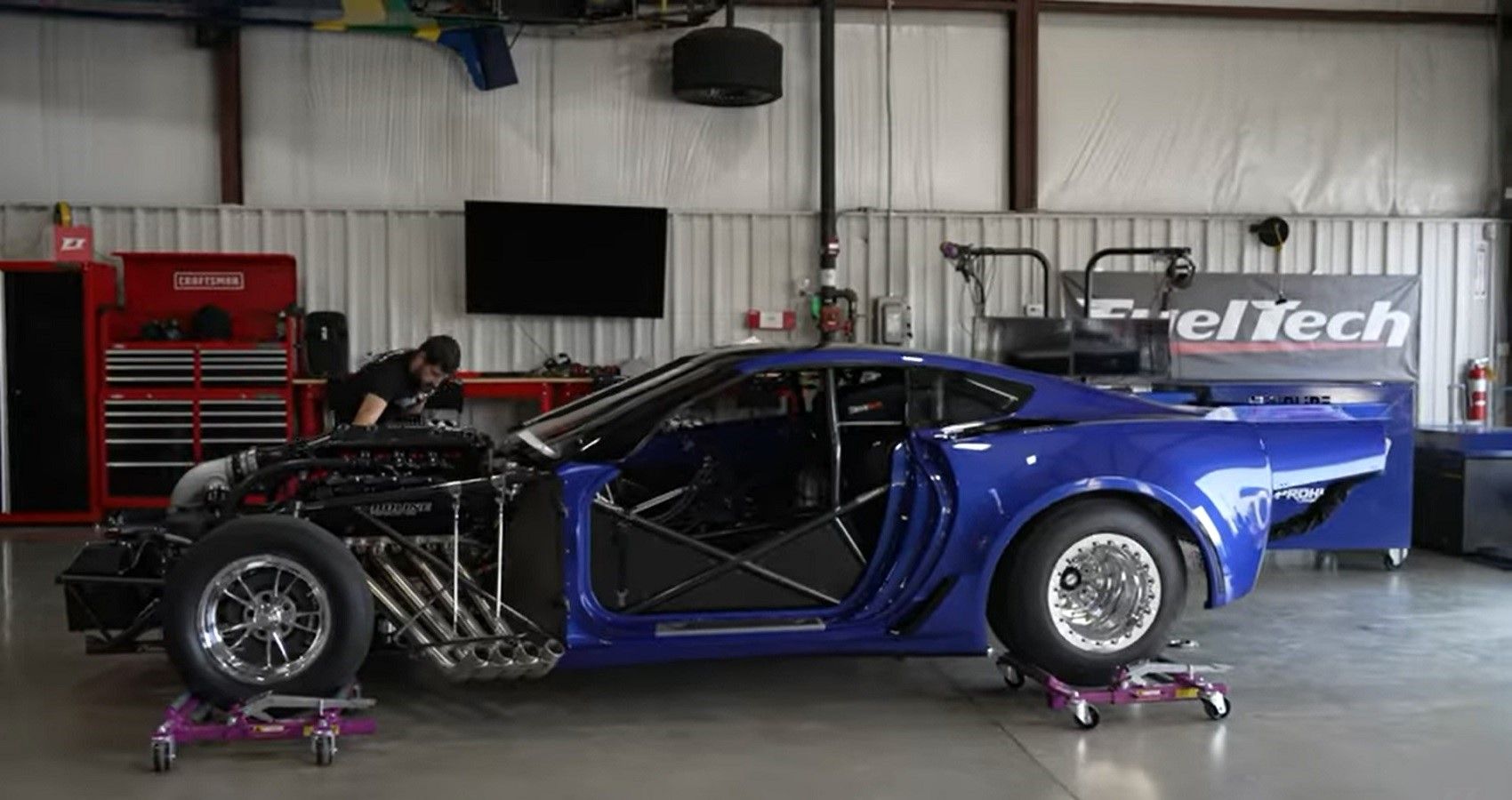 C7 Corvette drag racer, side profile view in garage workshop