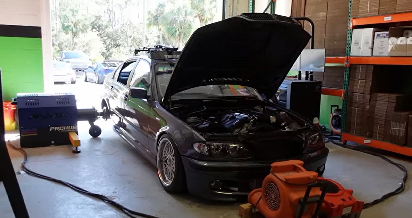 Adam LZ BMW E46 project on dyno, front quarter view of car in garage
