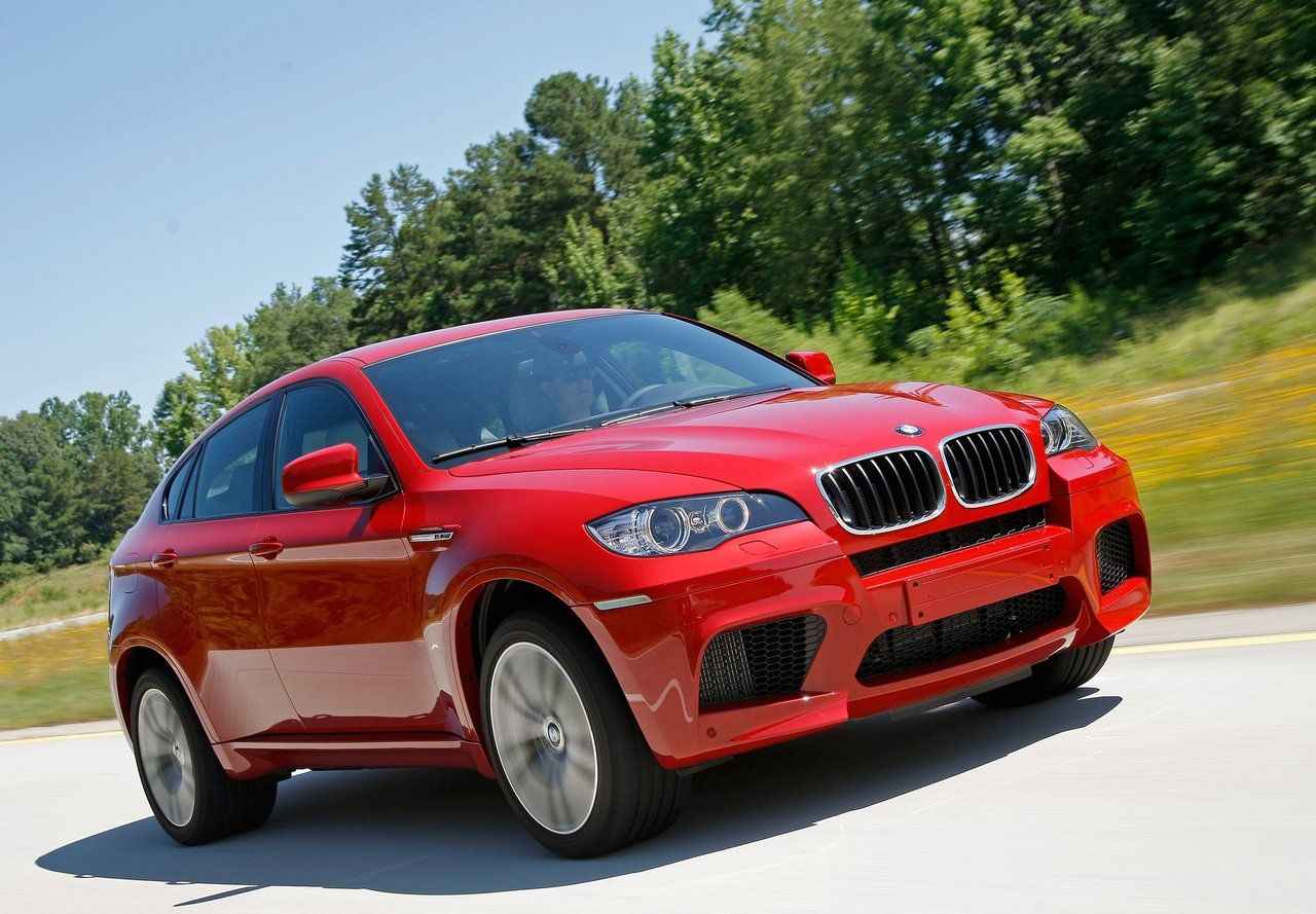 Red BMW X6M driving