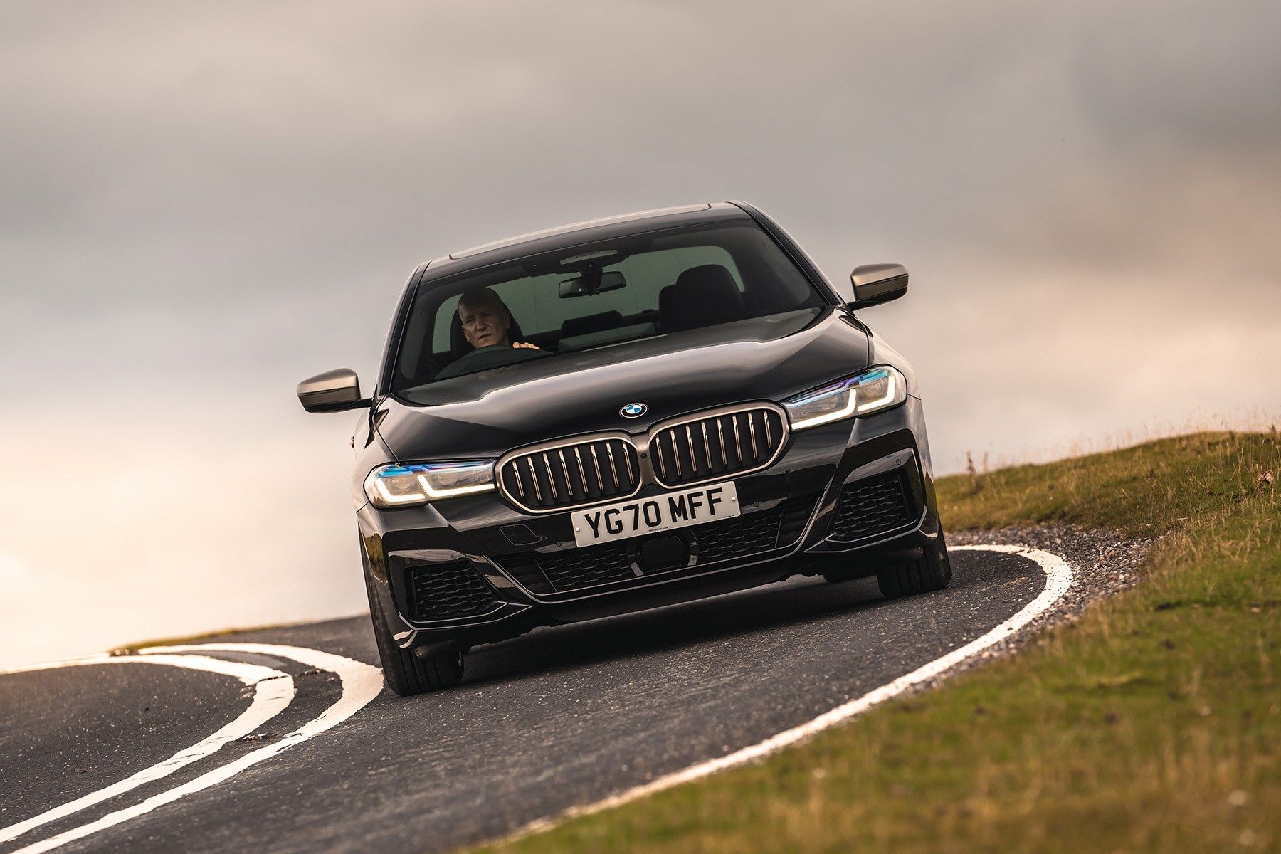 Driving a black BMW 5 Series 