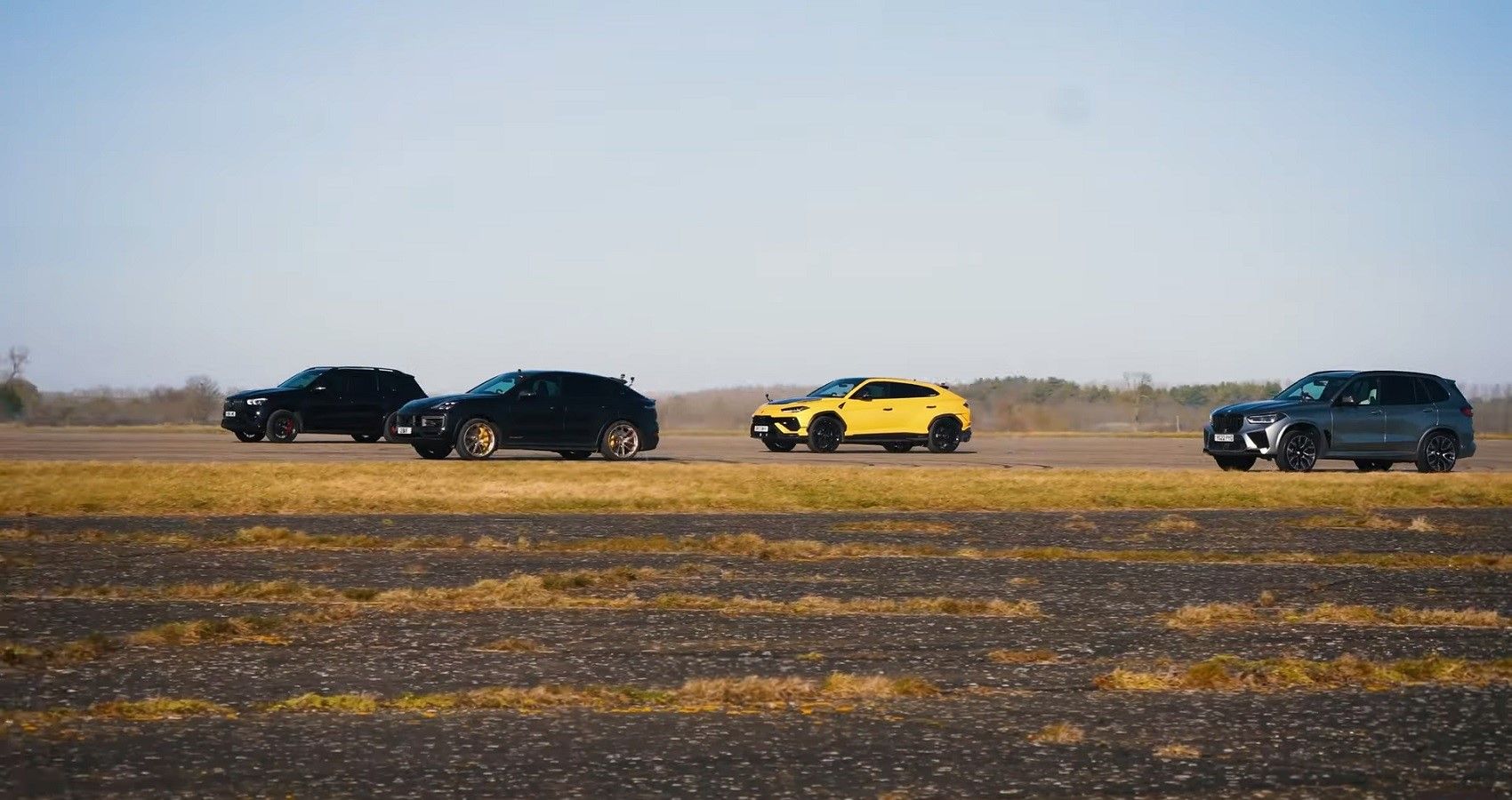 Fastest SUV drag race, SUVs in group accelerating towards camera on airfield