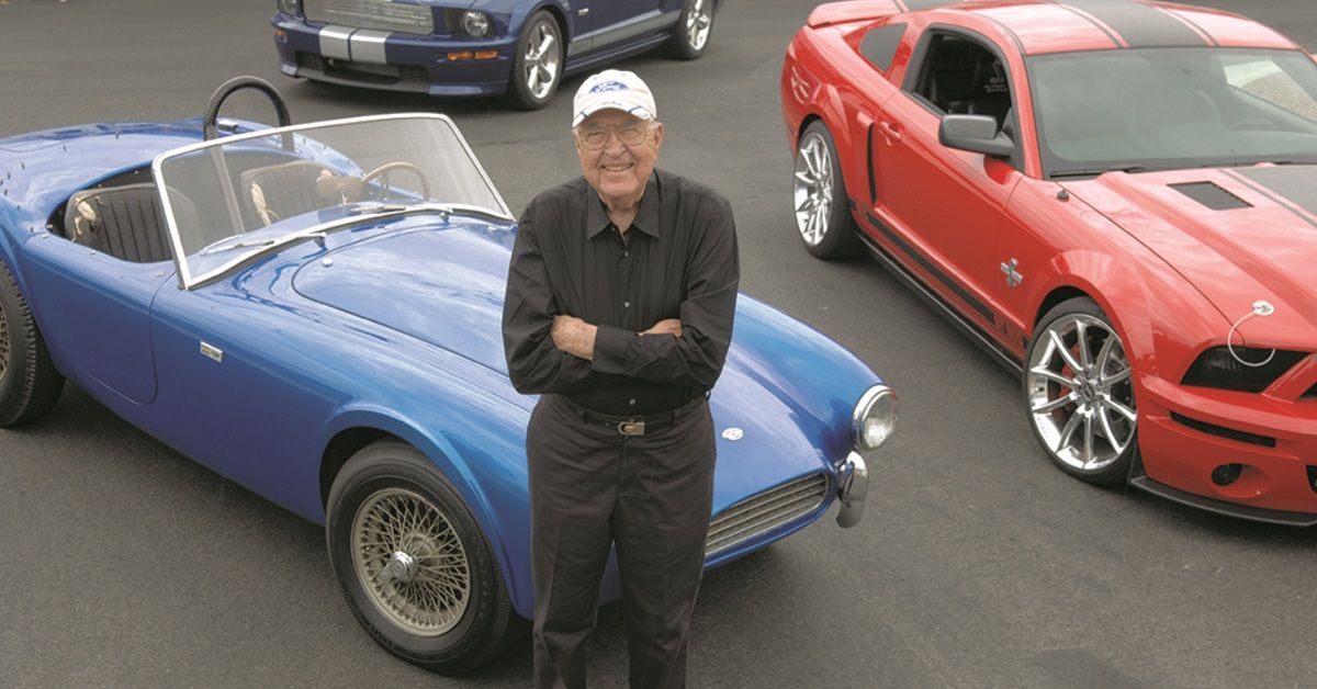 Carroll Shelby Standing Among His Cars