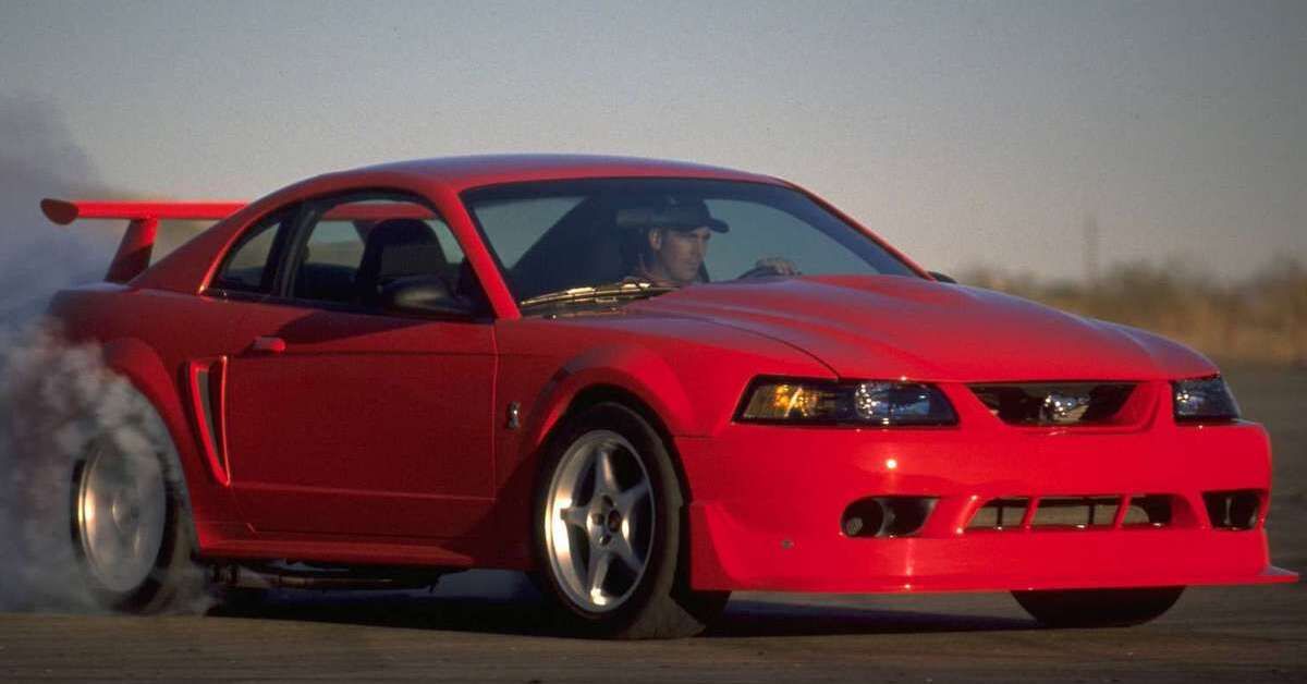 A red 2000 Ford Mustang SVT Cobra R doing exhausts