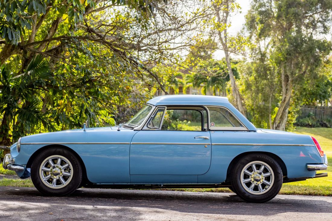 Light blue MGB roadster parked outdoors