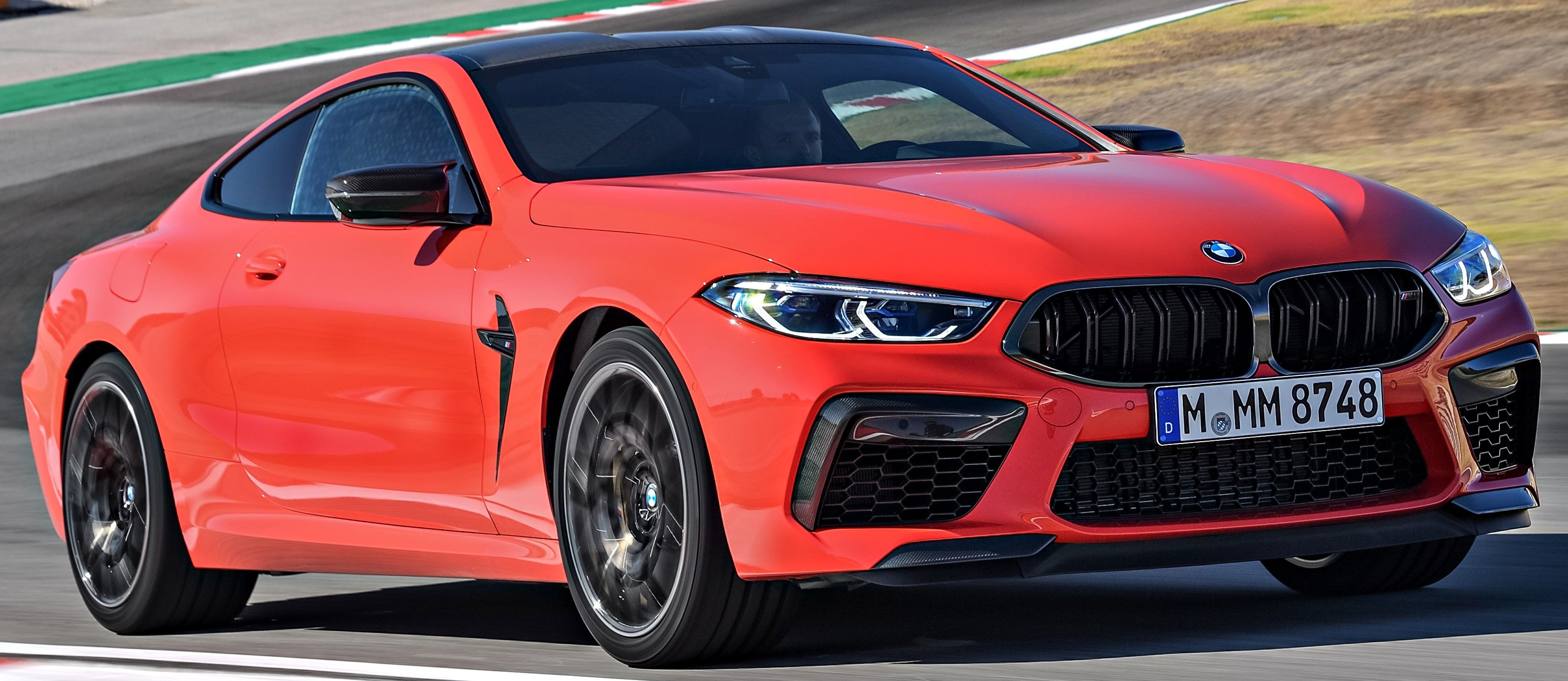 Red 2023 BMW M8 Competition Coupe driven on the track